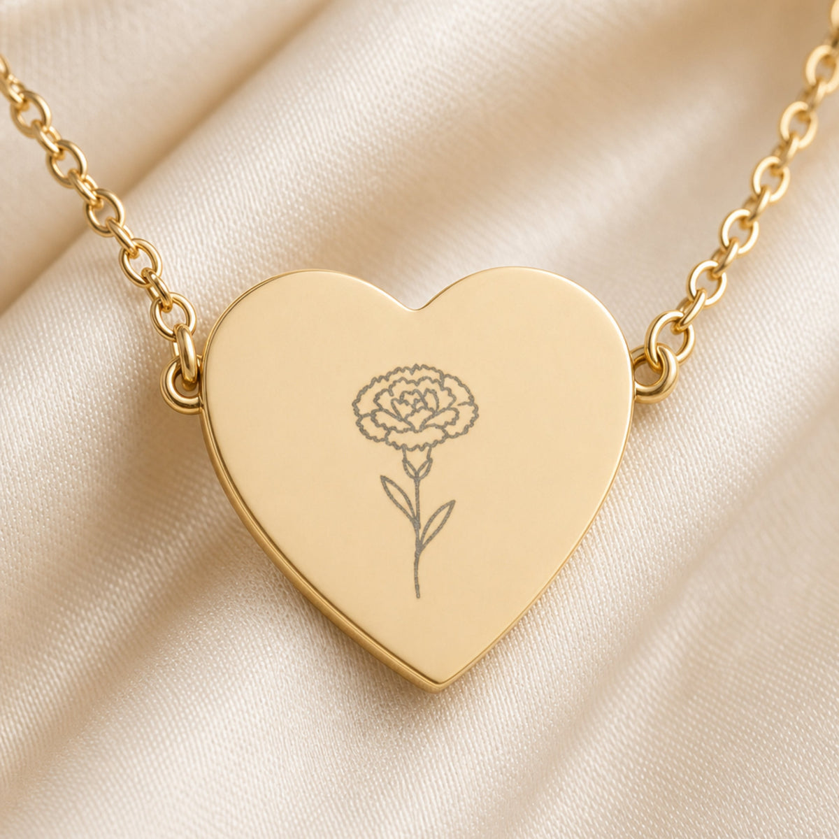 January carnation engraving close-up — laser-etched detail on heart pendant in 18K Gold PVD