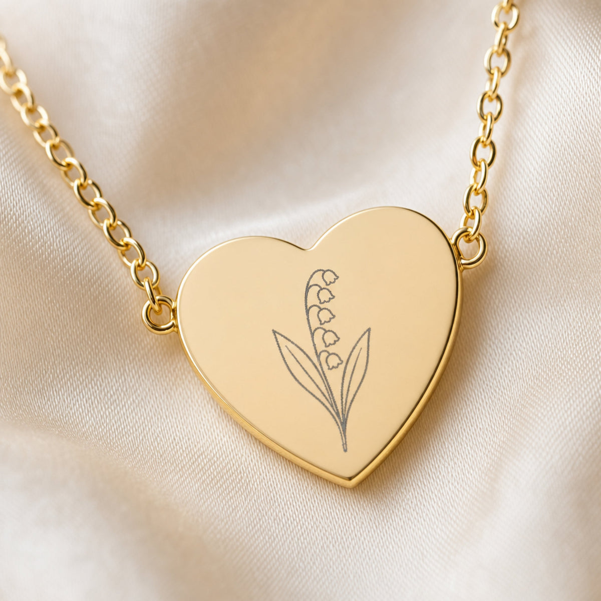 May lily of the valley engraving close-up — laser-etched detail on heart pendant in 18K Gold PVD