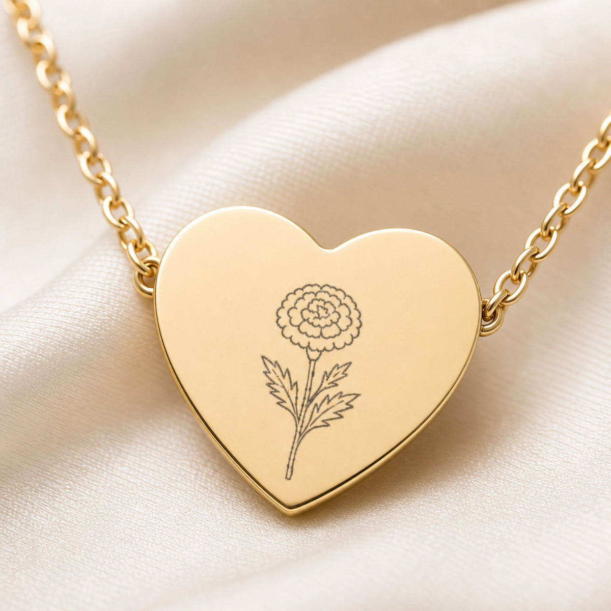 October marigold engraving close-up — laser-etched detail on heart pendant in 18K Gold PVD