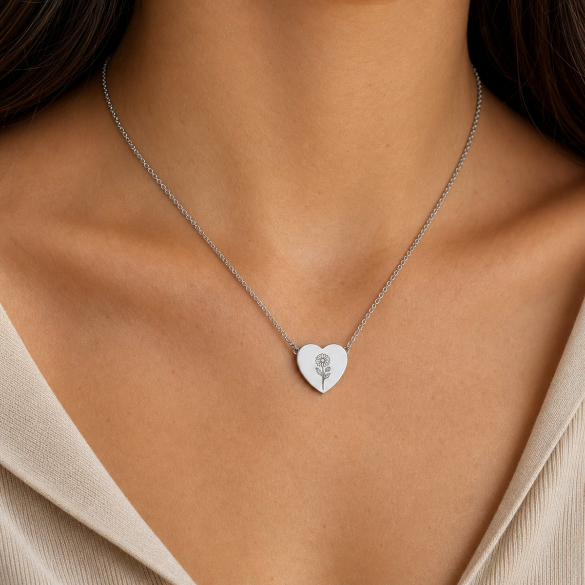 September birth flower necklace with aster engraving in polished 316L stainless steel, worn on model