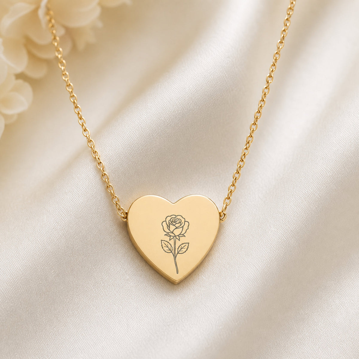 June birth flower necklace with rose engraving on linen flatlay with full chain