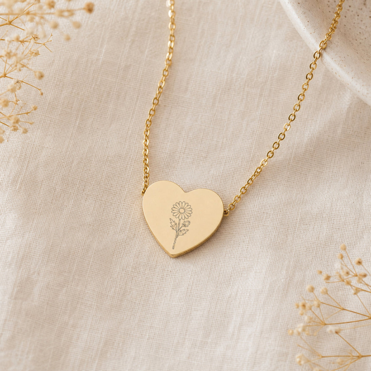 September birth flower necklace with aster engraving on linen flatlay with full chain