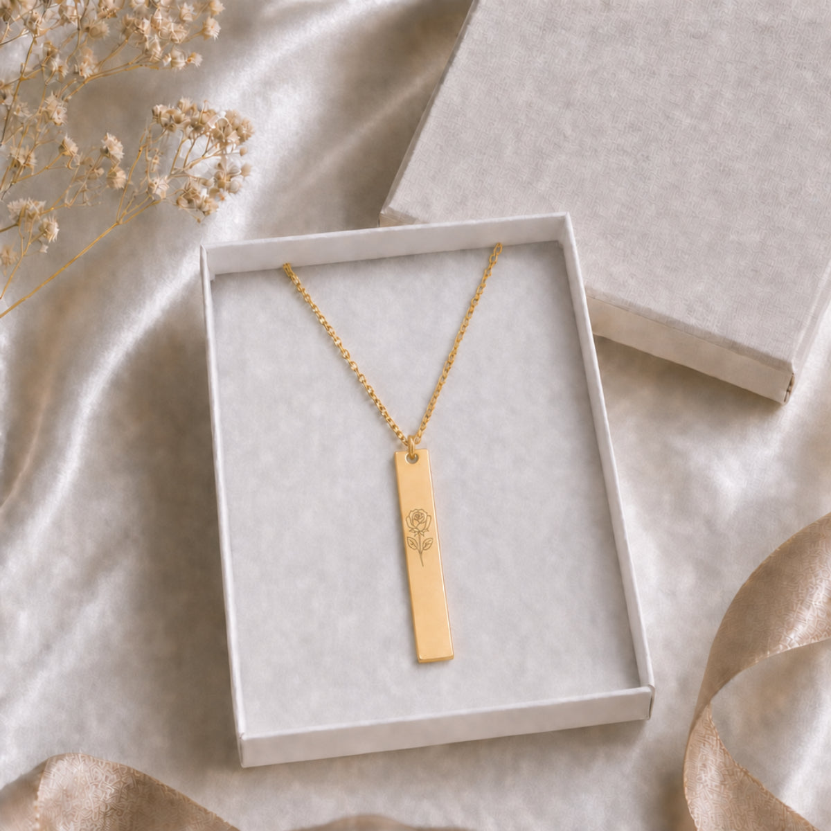 June birth flower necklace — Rose engraved vertical bar pendant in cream gift-ready box, premium editorial unboxing