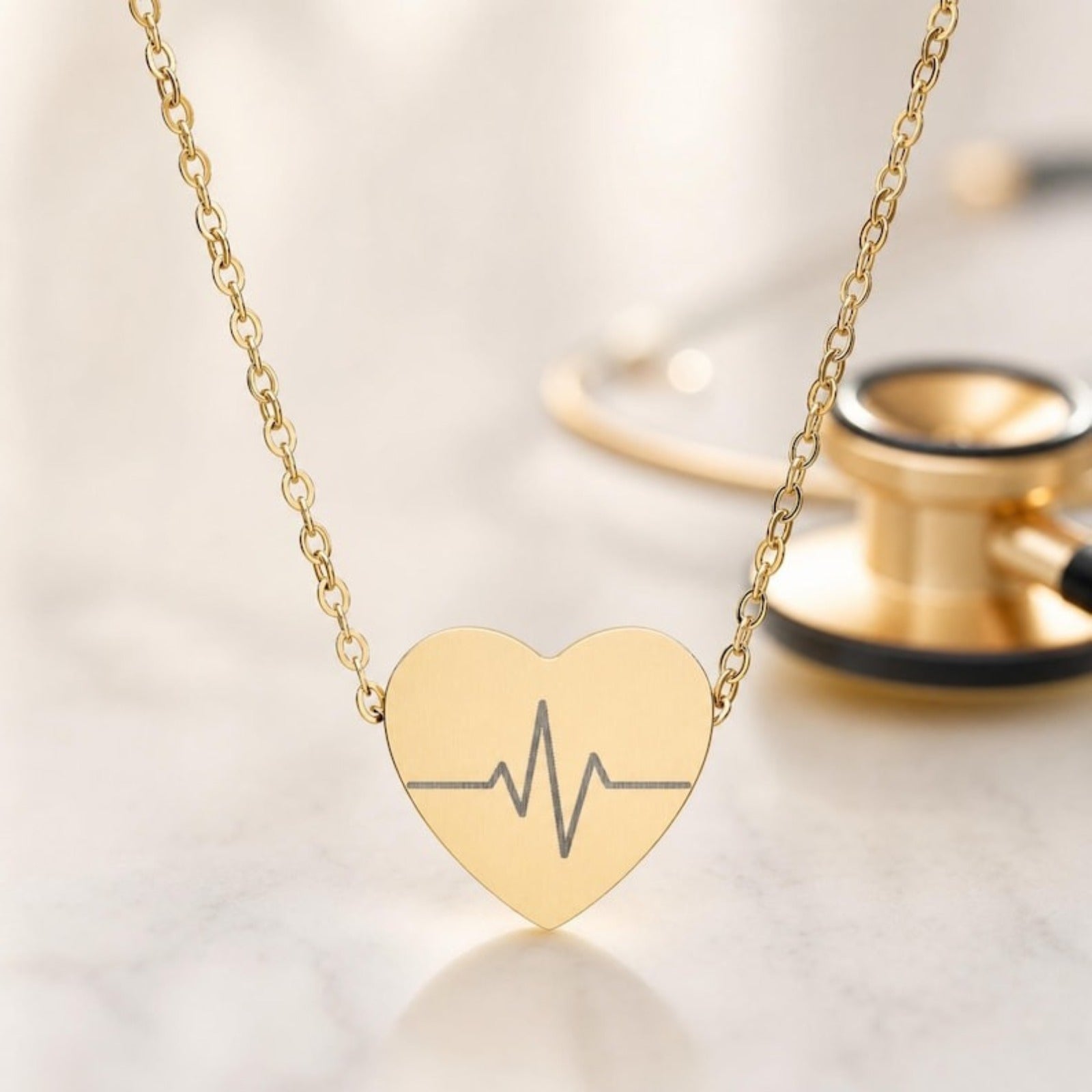 Heartbeat necklace closeup — engraved EKG line on 18K Gold PVD heart pendant with stethoscope blur. Memory That Lasts.