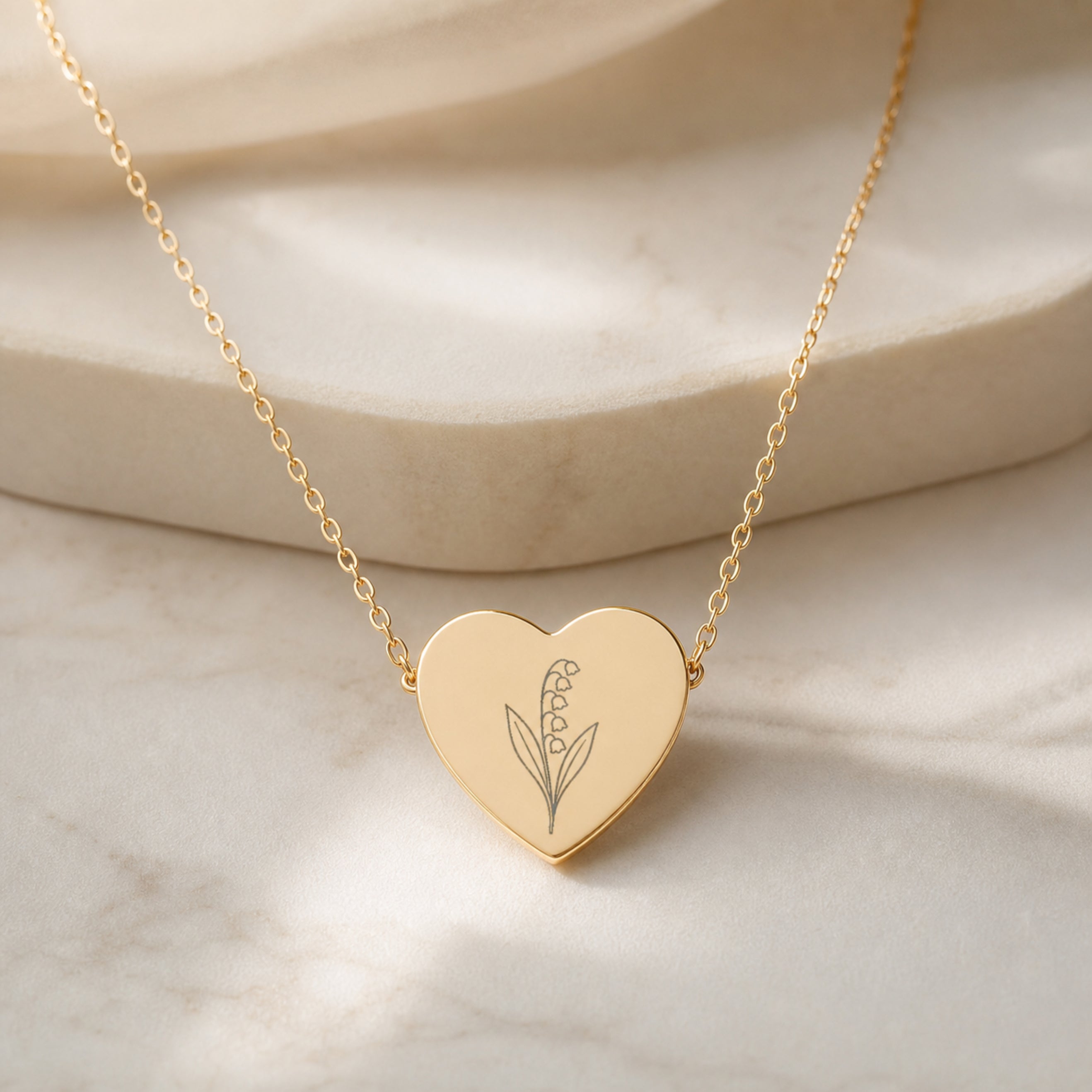 May birth flower necklace — lily of the valley heart pendant hero with lily of the valley blooms