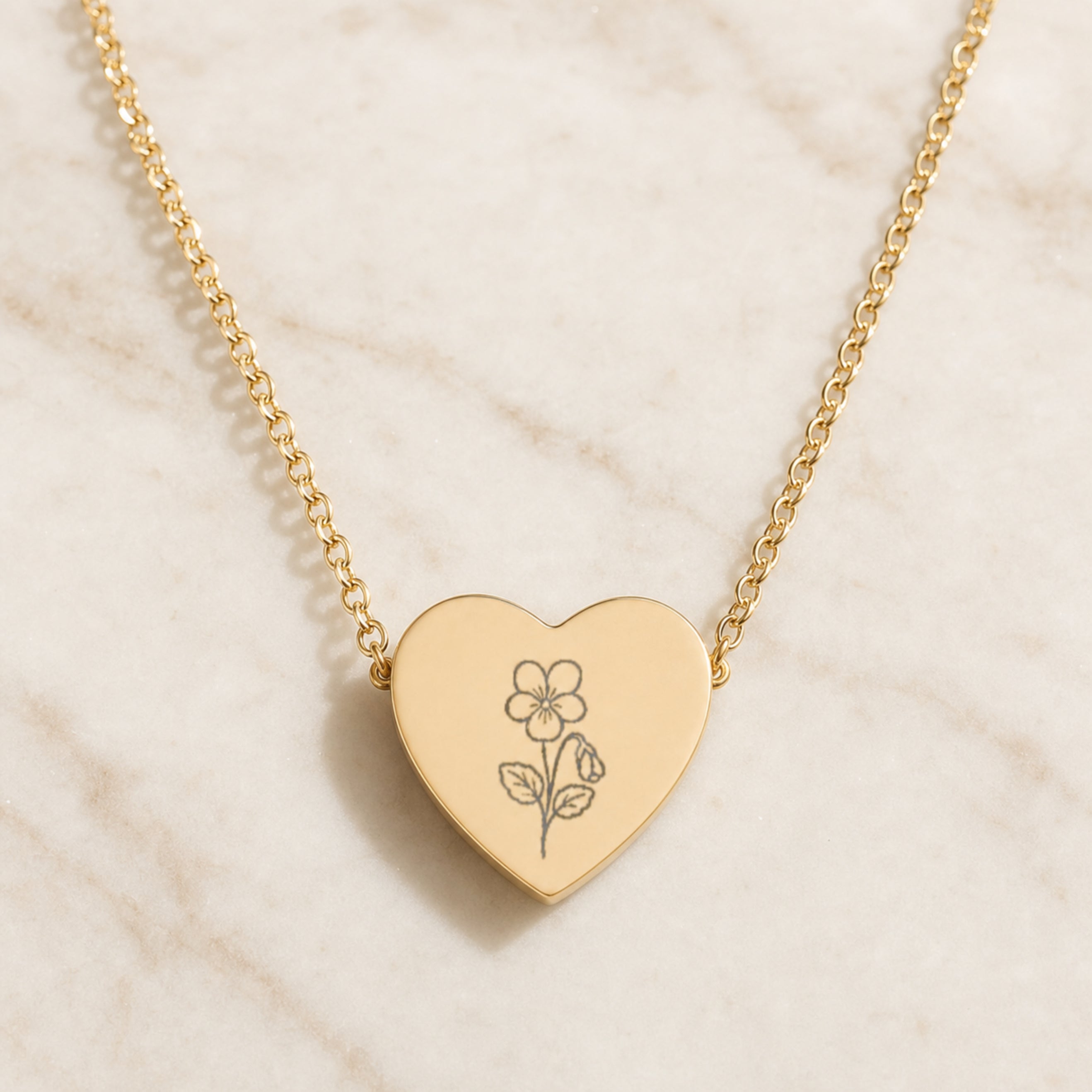 February violet engraving close-up — laser-etched detail on heart pendant in 18K Gold PVD