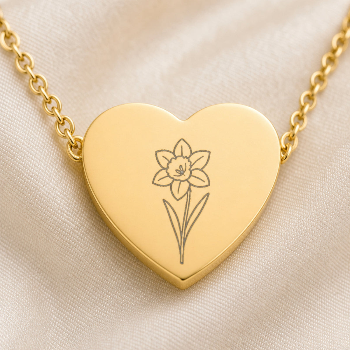 March daffodil engraving close-up — laser-etched detail on heart pendant in 18K Gold PVD