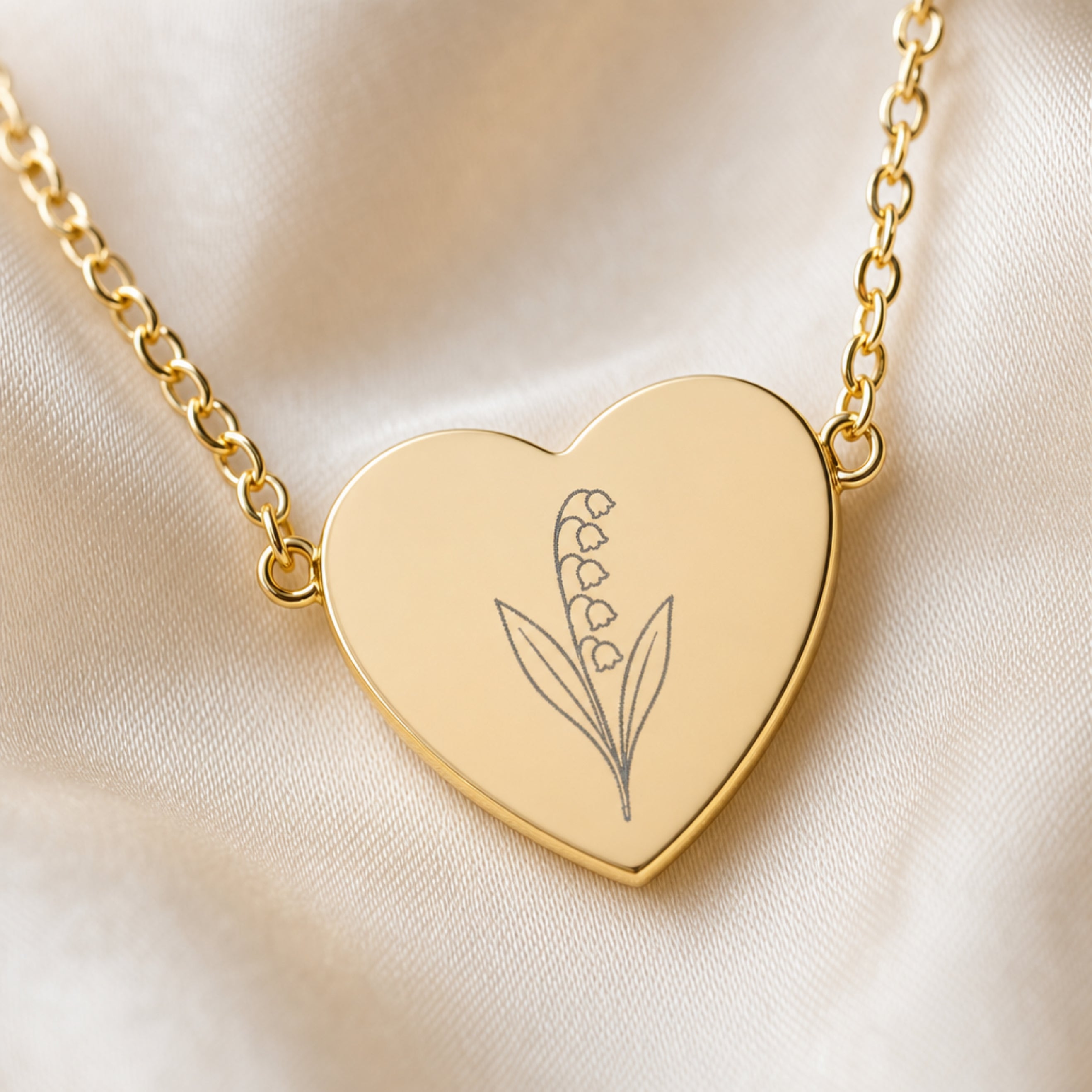 May lily of the valley engraving close-up — laser-etched detail on heart pendant in 18K Gold PVD