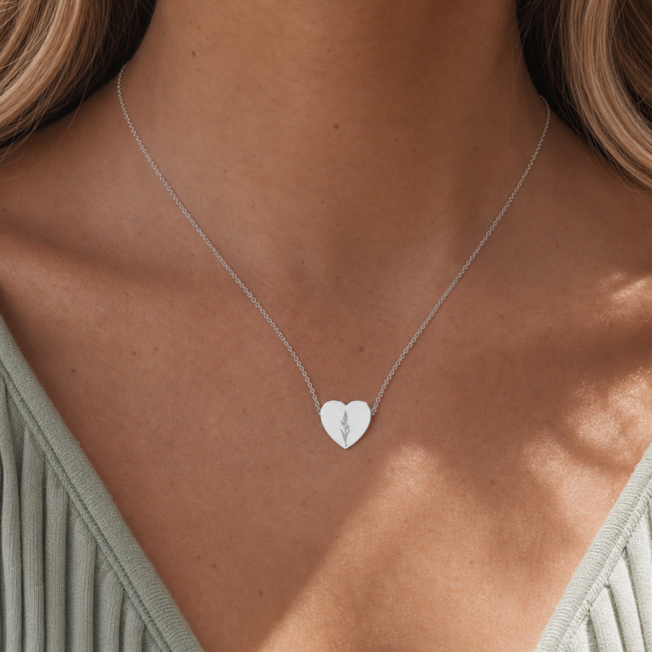 August birth flower necklace with gladiolus engraving in polished 316L stainless steel, worn on model