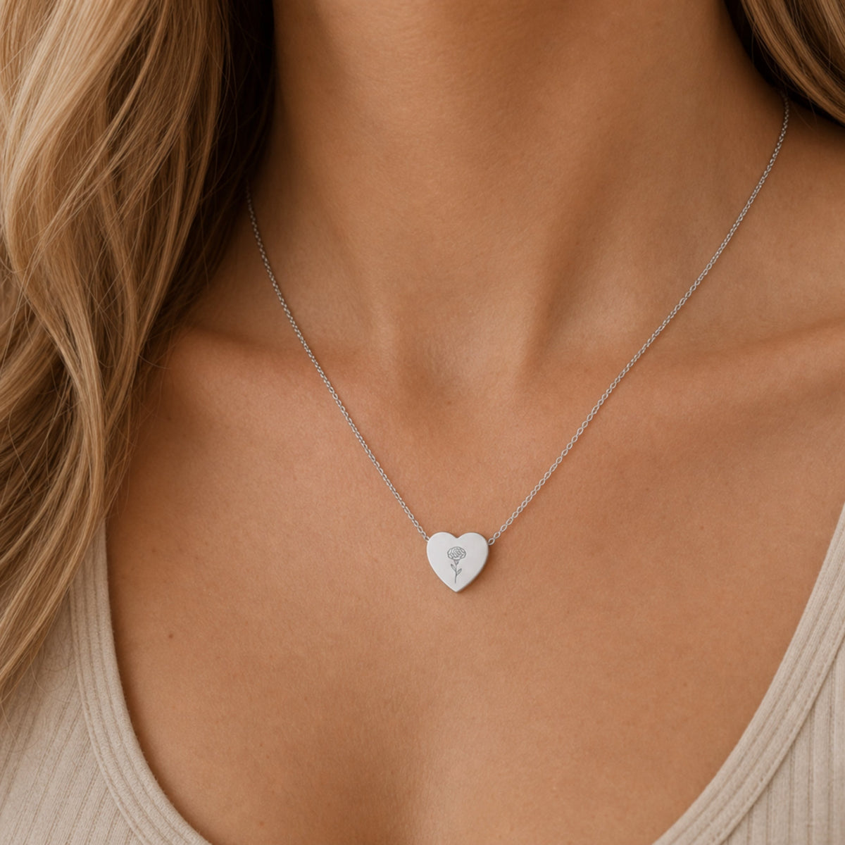 January birth flower necklace with carnation engraving in polished 316L stainless steel, worn on model