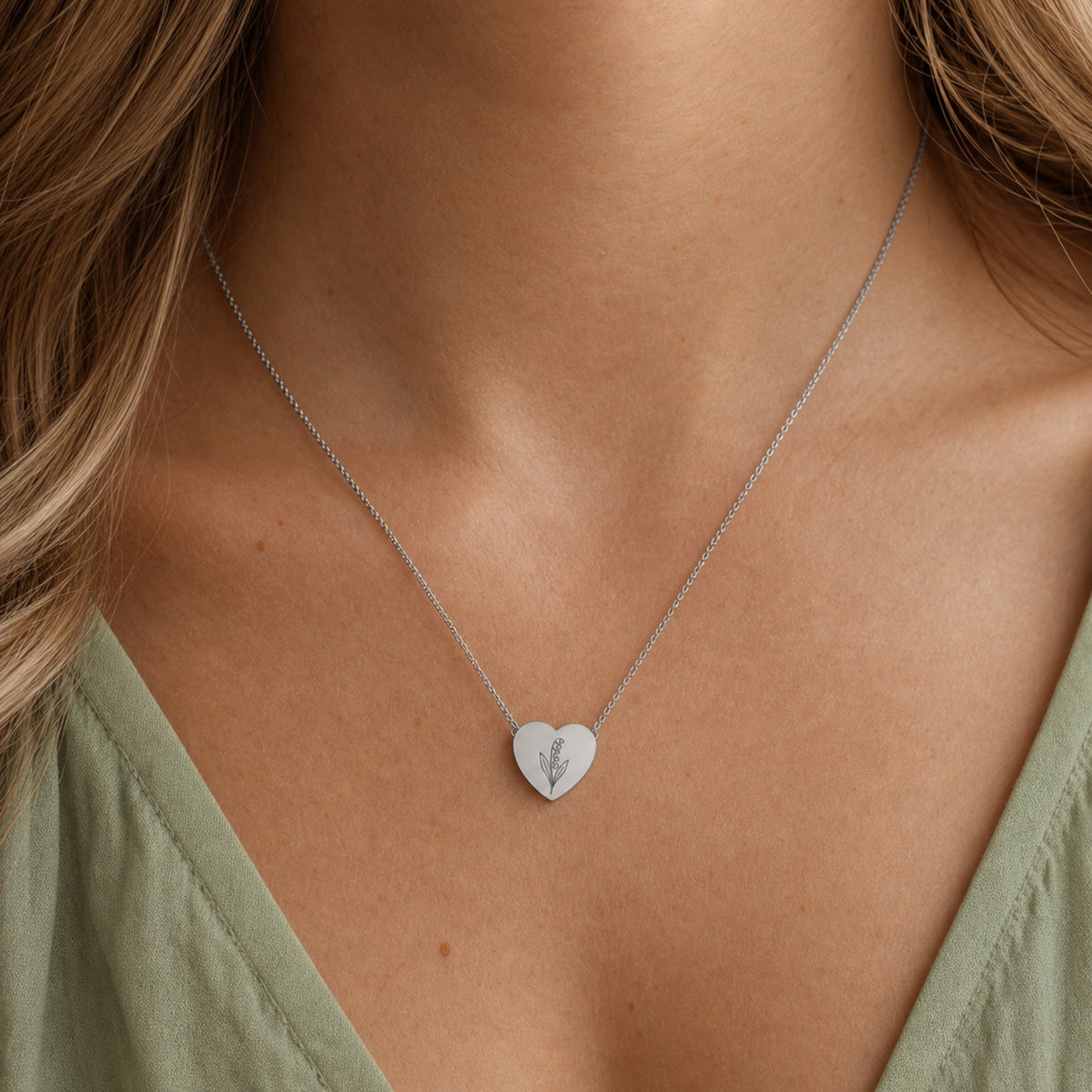 May birth flower necklace with lily of the valley engraving in polished 316L stainless steel, worn on model