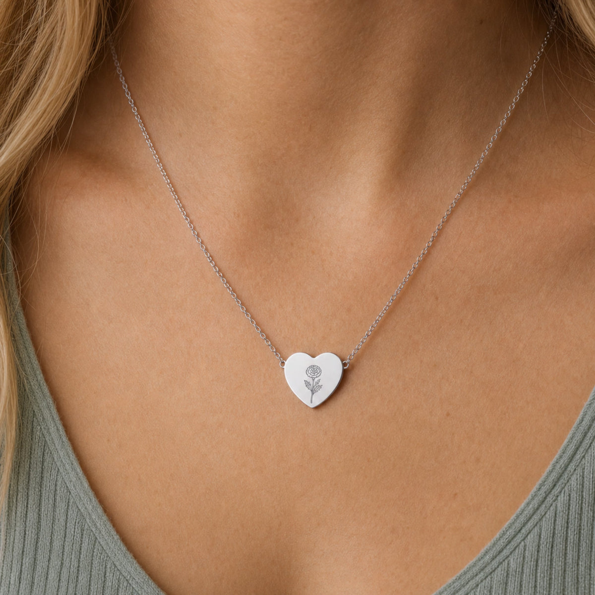 October birth flower necklace with marigold engraving in polished 316L stainless steel, worn on model