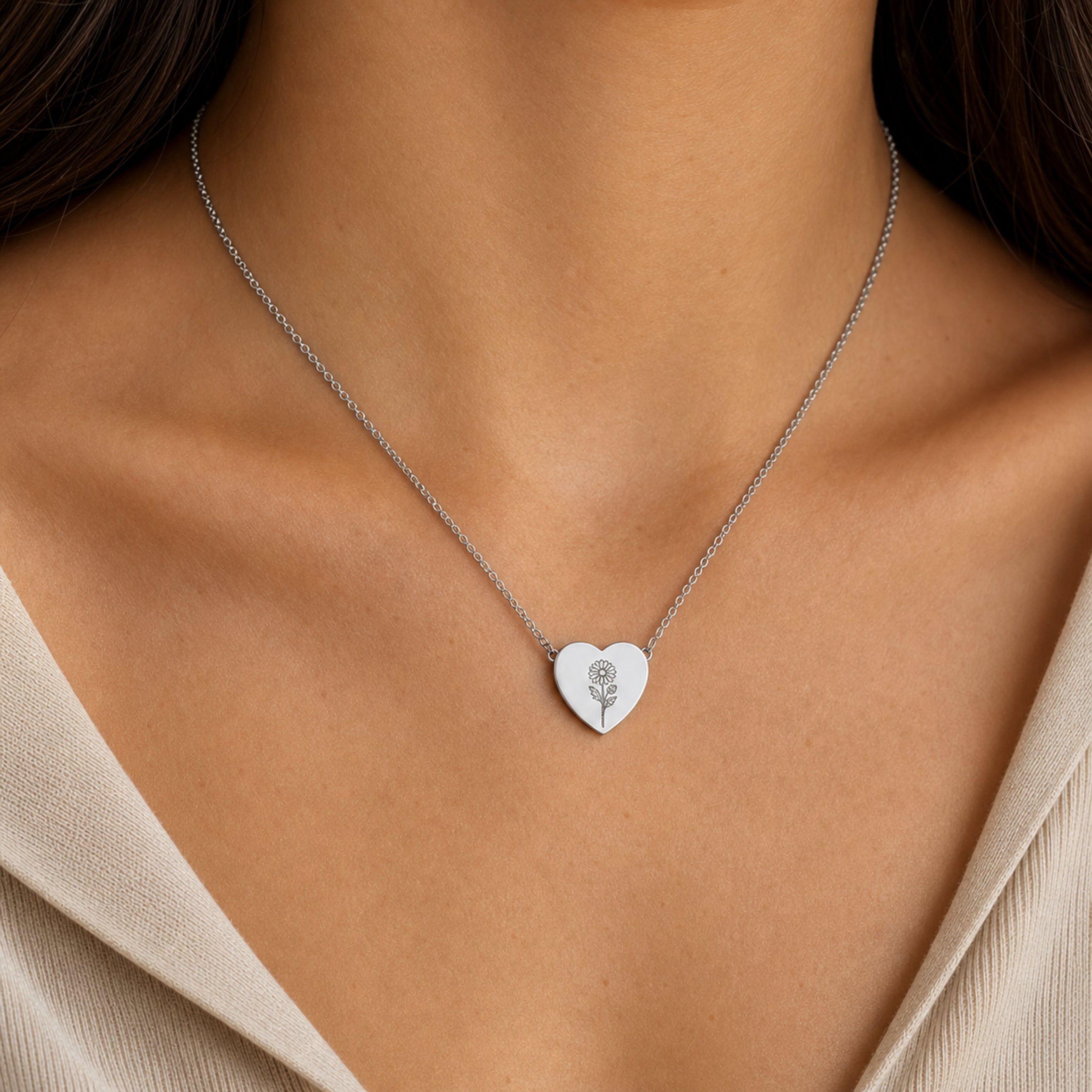 September birth flower necklace with aster engraving in polished 316L stainless steel, worn on model