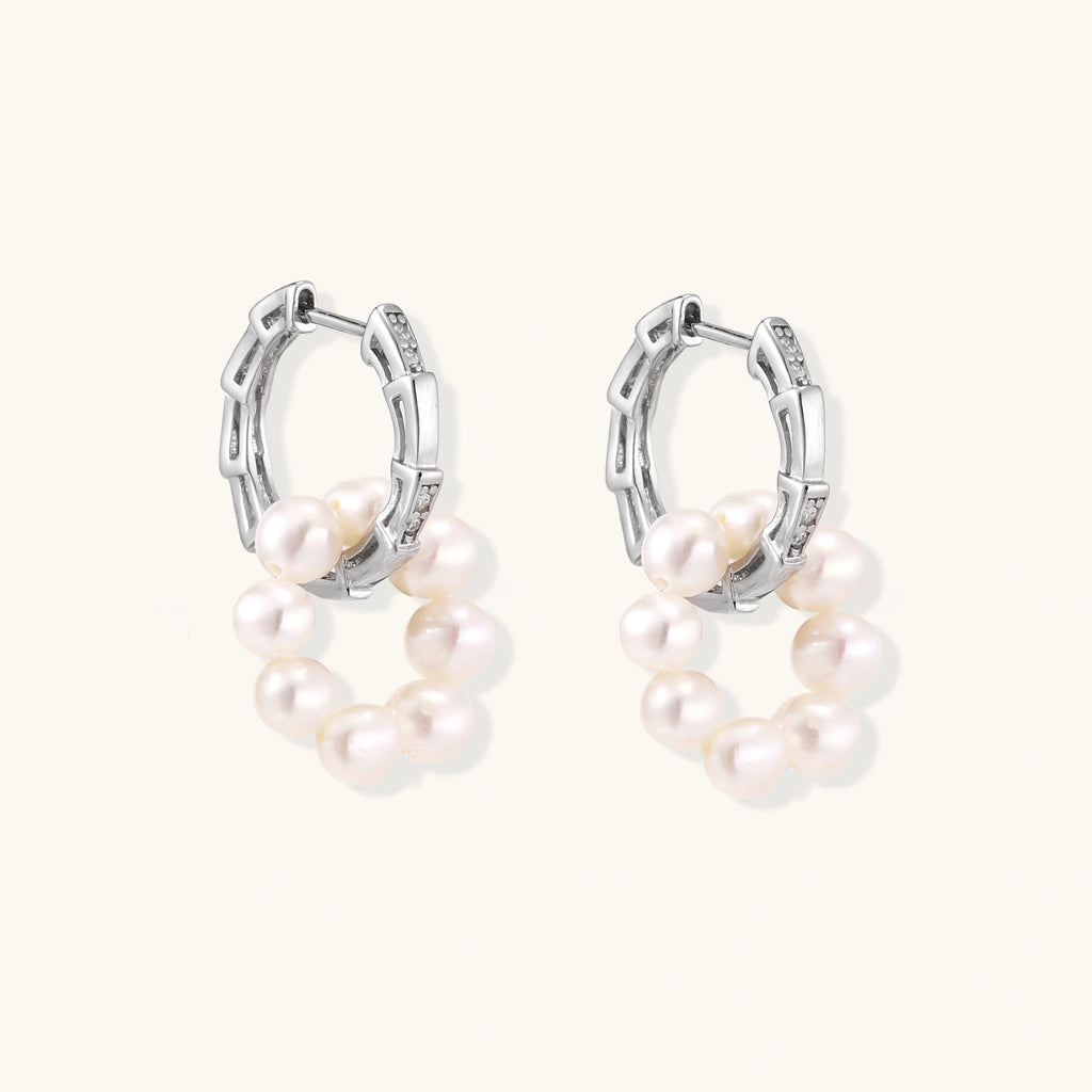 Rhodium-plated silver hoop earrings with freshwater pearls arranged in crescent formation and crystal accents