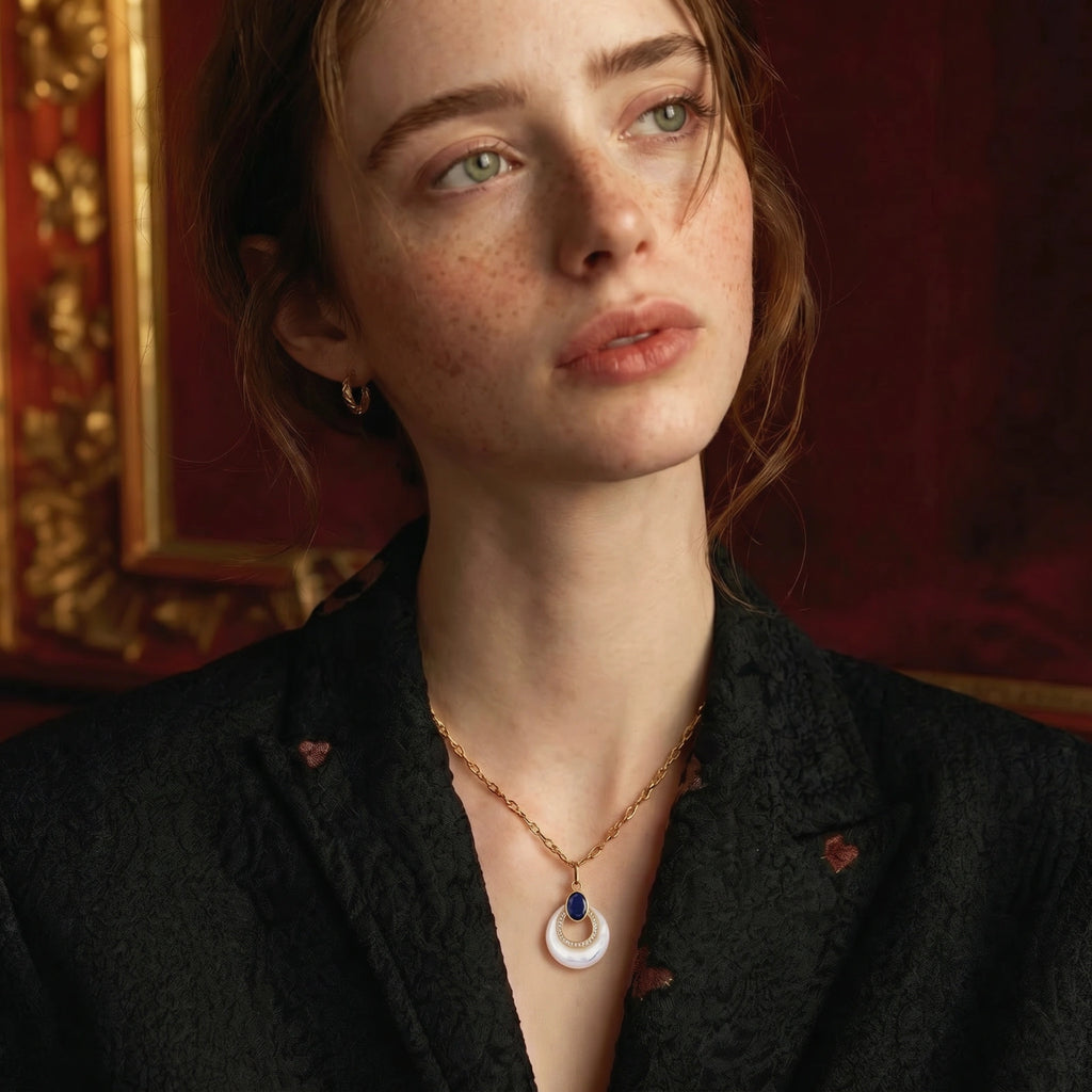 Mystic Pearl gold necklace with a mother-of-pearl teardrop, blue lapis cabochon, and crystal accents