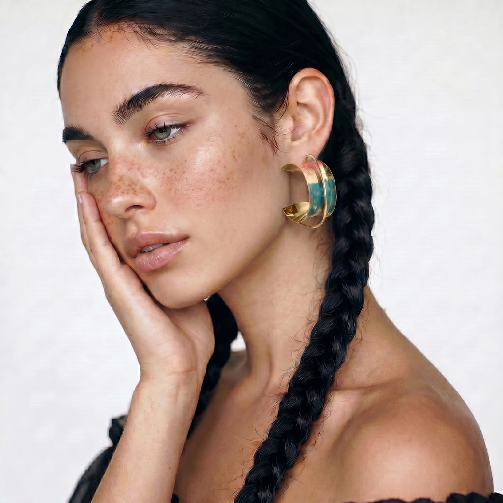 Sunset Mirage gold hoop earrings with coral and teal enamel shown from the side