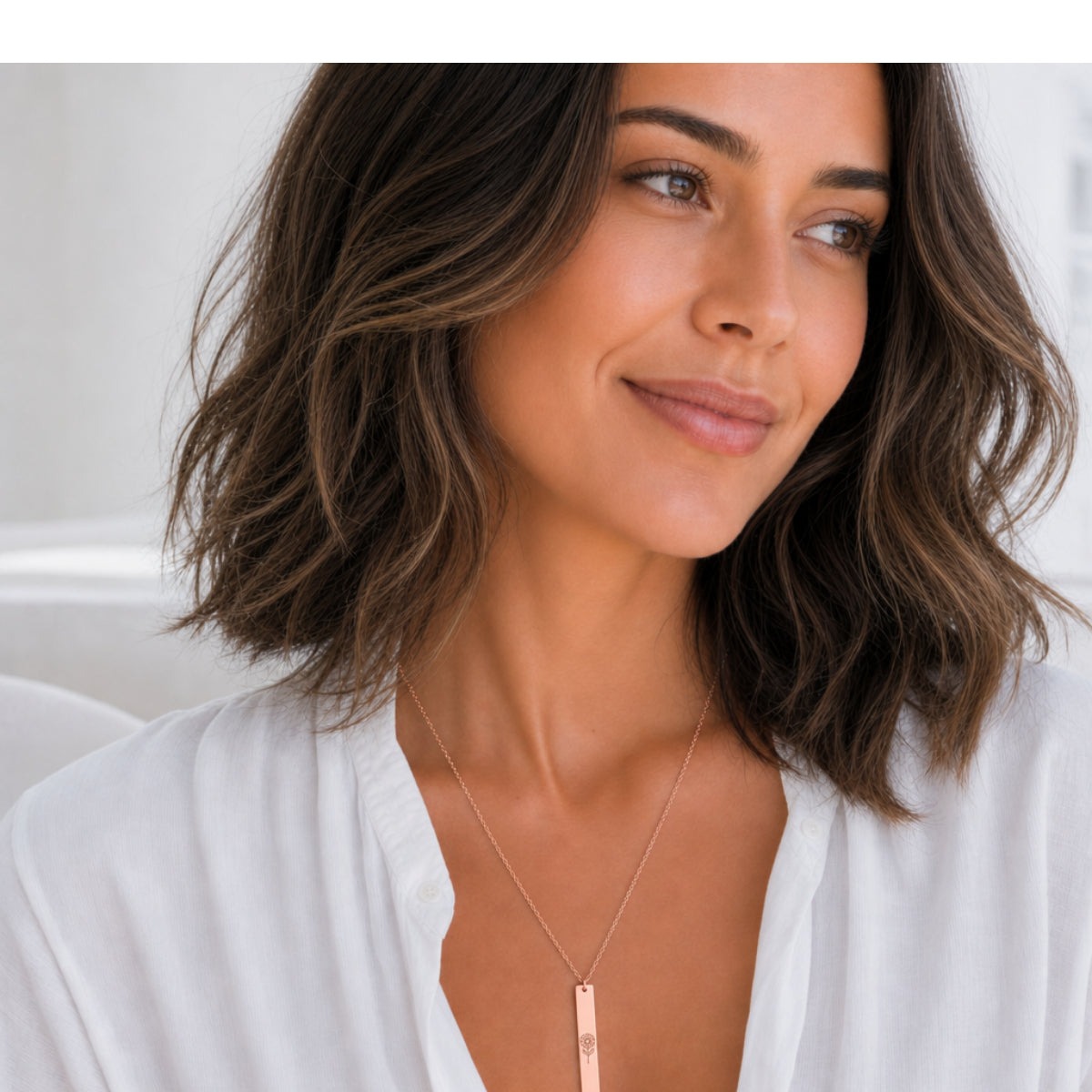 April birth flower necklace — Daisy engraved vertical bar pendant, 18K Rose Gold PVD finish, model wearing pendant, on-neck lifestyle