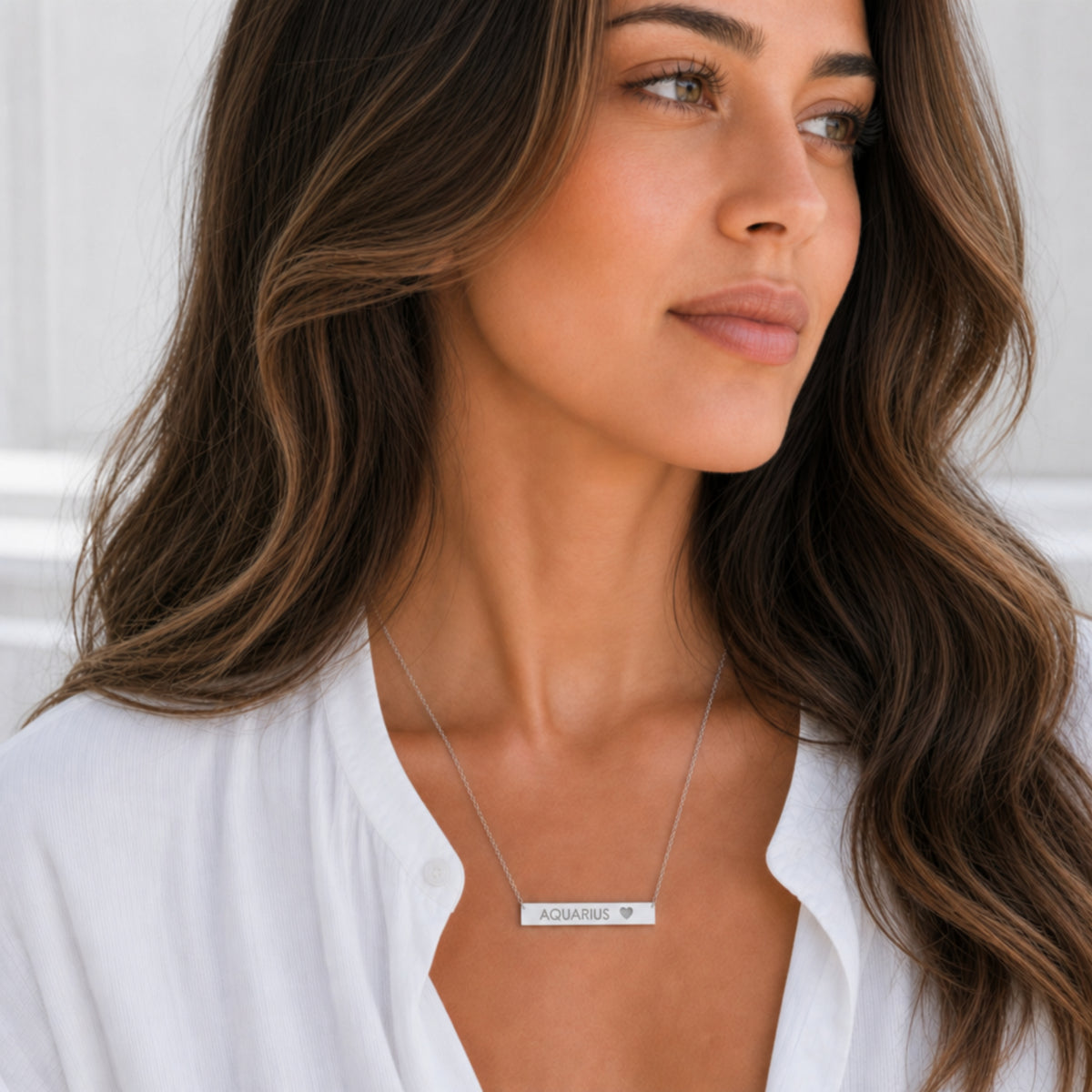 Aquarius zodiac necklace — cutout heart bar pendant, 316L stainless steel polished mirror finish, model wearing pendant, on-neck lifestyle
