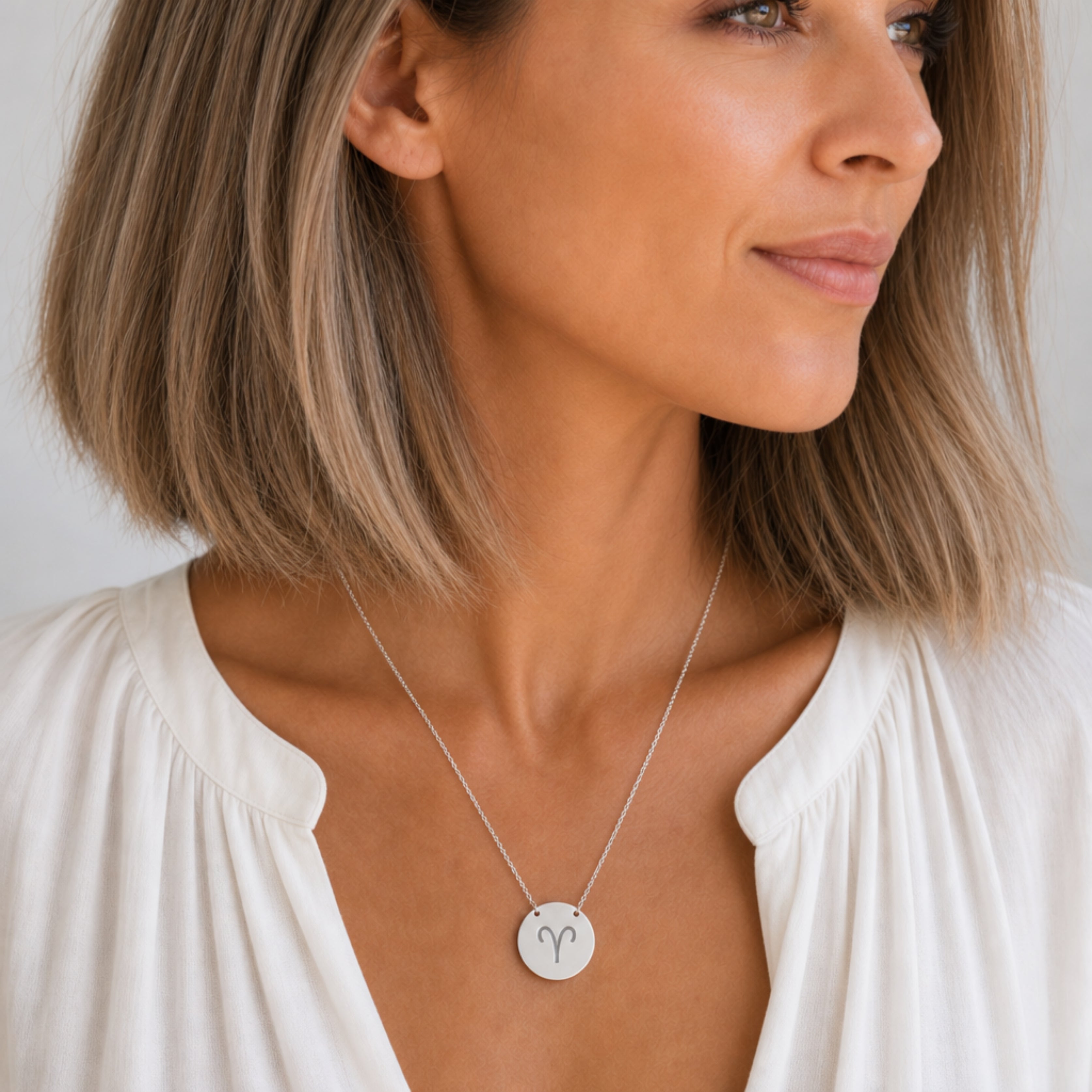 Aries zodiac coin necklace in stainless steel, laser-engraved Aries star sign pendant, worn on model