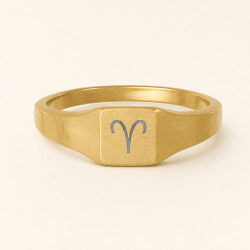 Aries zodiac square signet ring studio front — clean cream backdrop product shot, 18K gold matte PVD