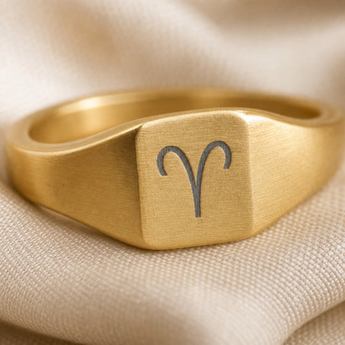 Aries zodiac square signet ring engraving close-up — laser-etched Ram detail, brushed grey on matte gold