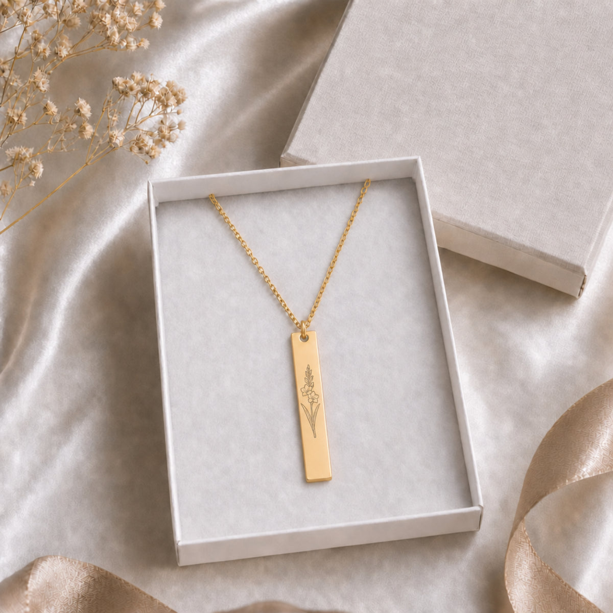 August birth flower necklace — Gladiolus engraved vertical bar pendant in cream gift-ready box, premium editorial unboxing