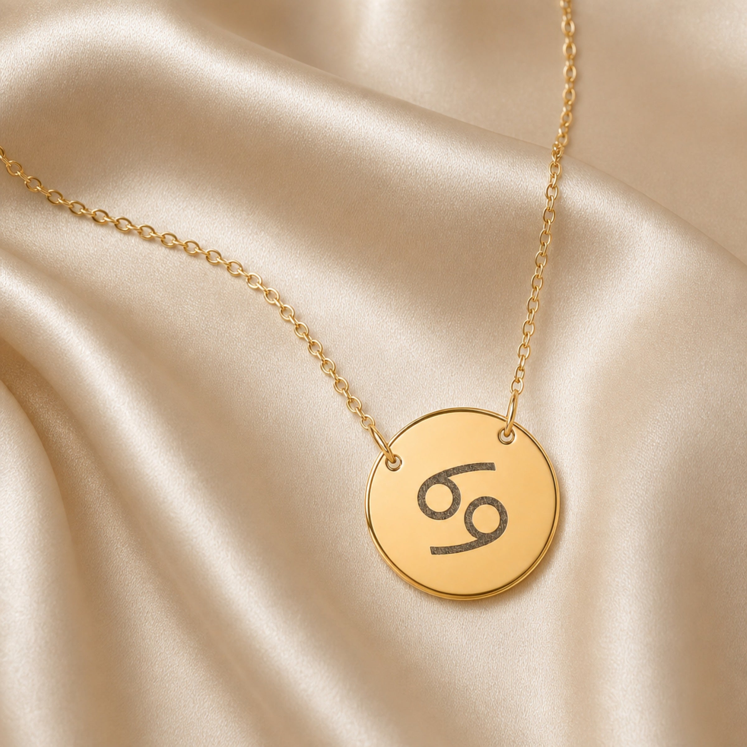 Cancer Coin Gold necklace flatlay — 18K gold pendant engraved with Cancer Crab star sign on cream silk, premium personalized astrology zodiac necklace gift for July birthday, Cancerian woman, mother, daughter