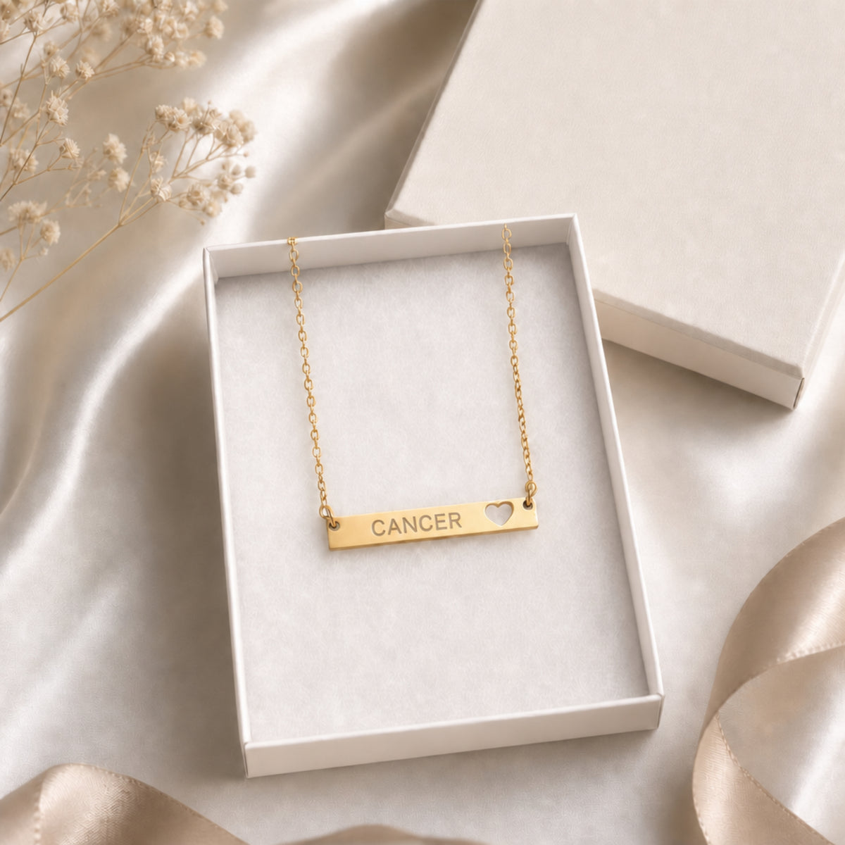 Cancer zodiac necklace — cutout heart bar pendant in cream gift-ready box, premium editorial unboxing