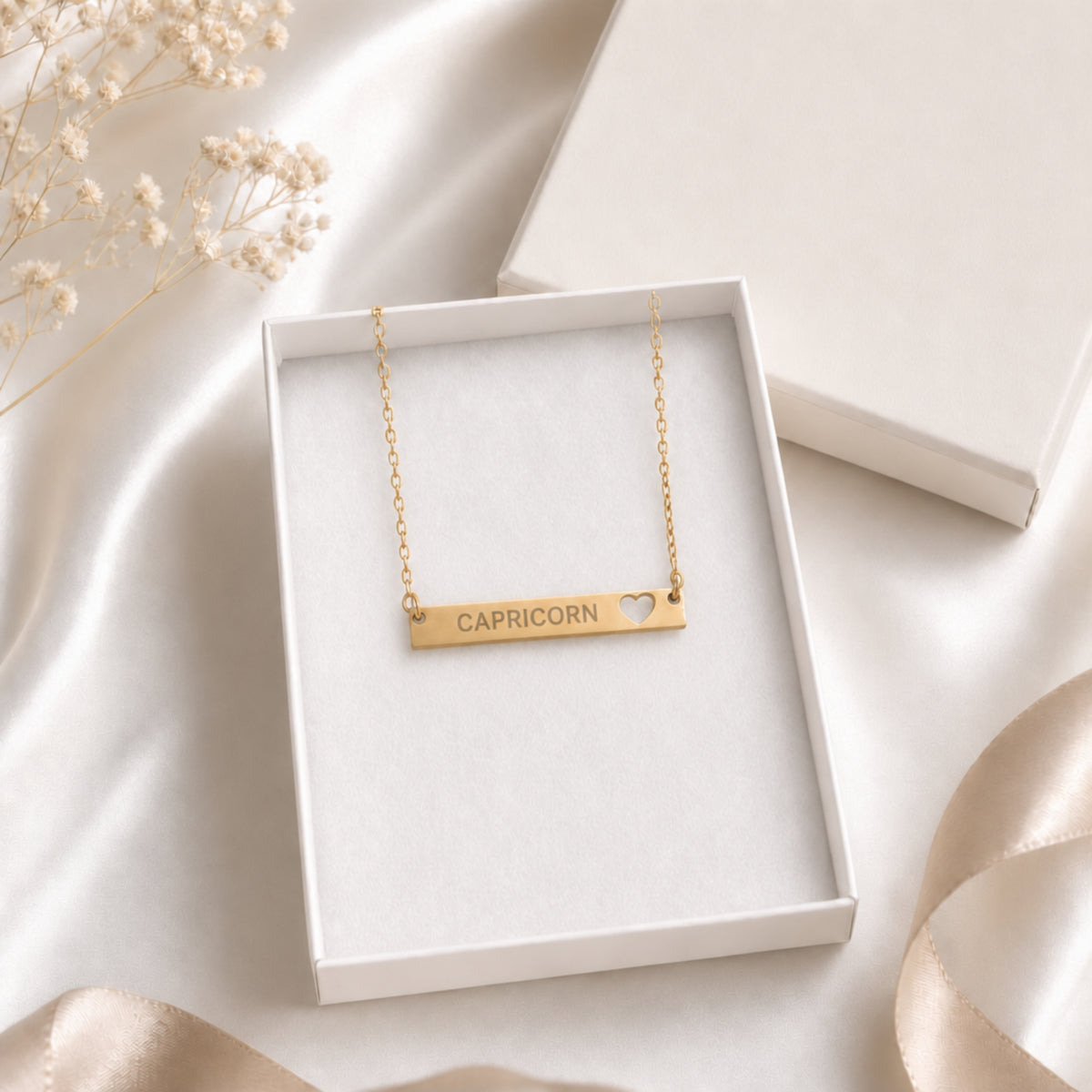 Capricorn zodiac necklace — cutout heart bar pendant in cream gift-ready box, premium editorial unboxing