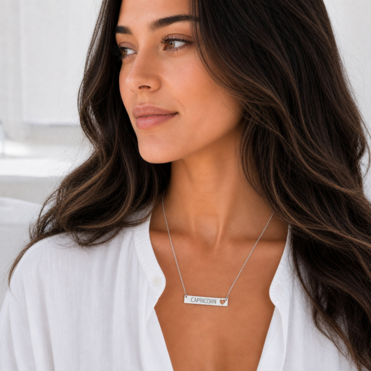Capricorn zodiac necklace — cutout heart bar pendant, 316L stainless steel polished mirror finish, model wearing pendant, on-neck lifestyle