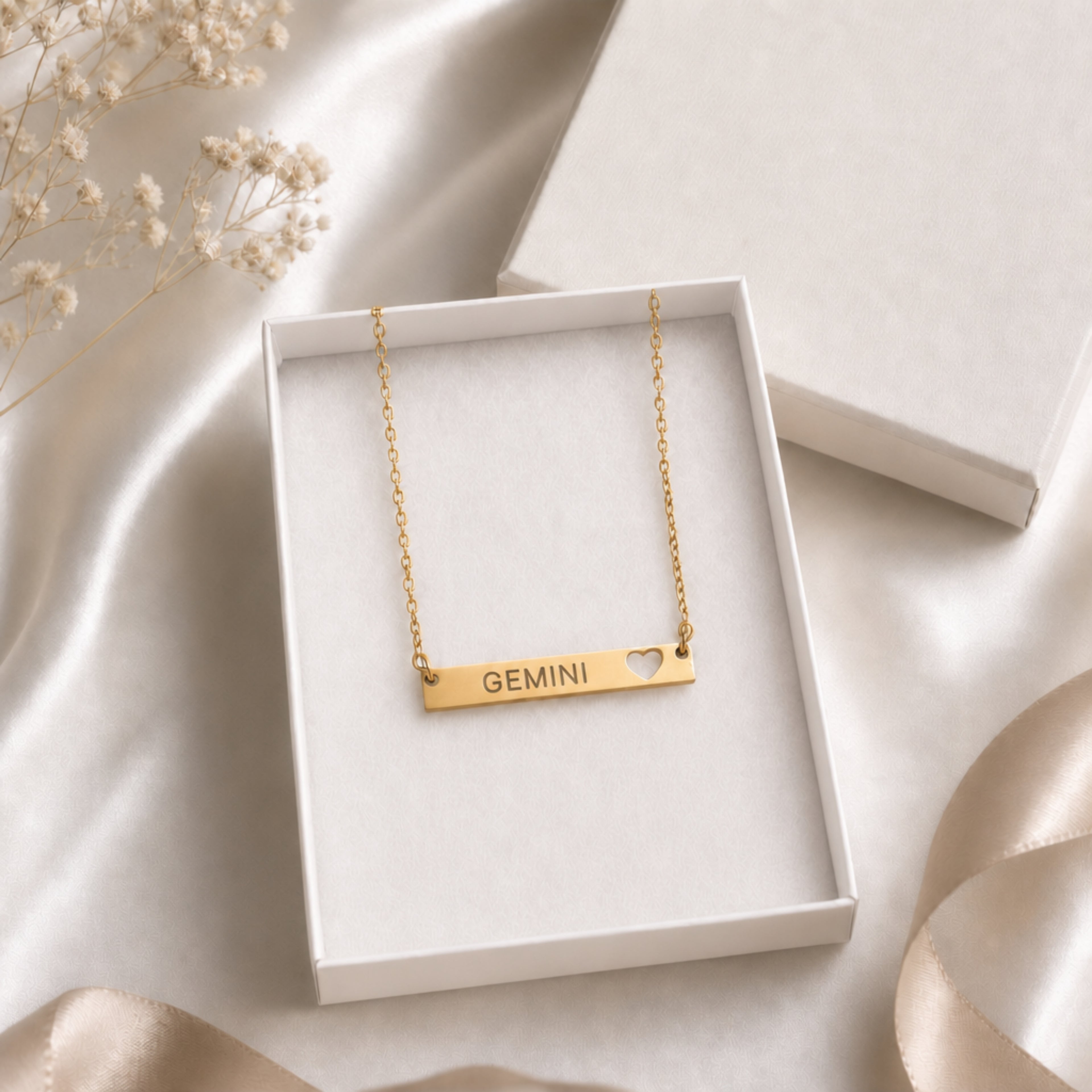 Gemini zodiac necklace — cutout heart bar pendant in cream gift-ready box, premium editorial unboxing