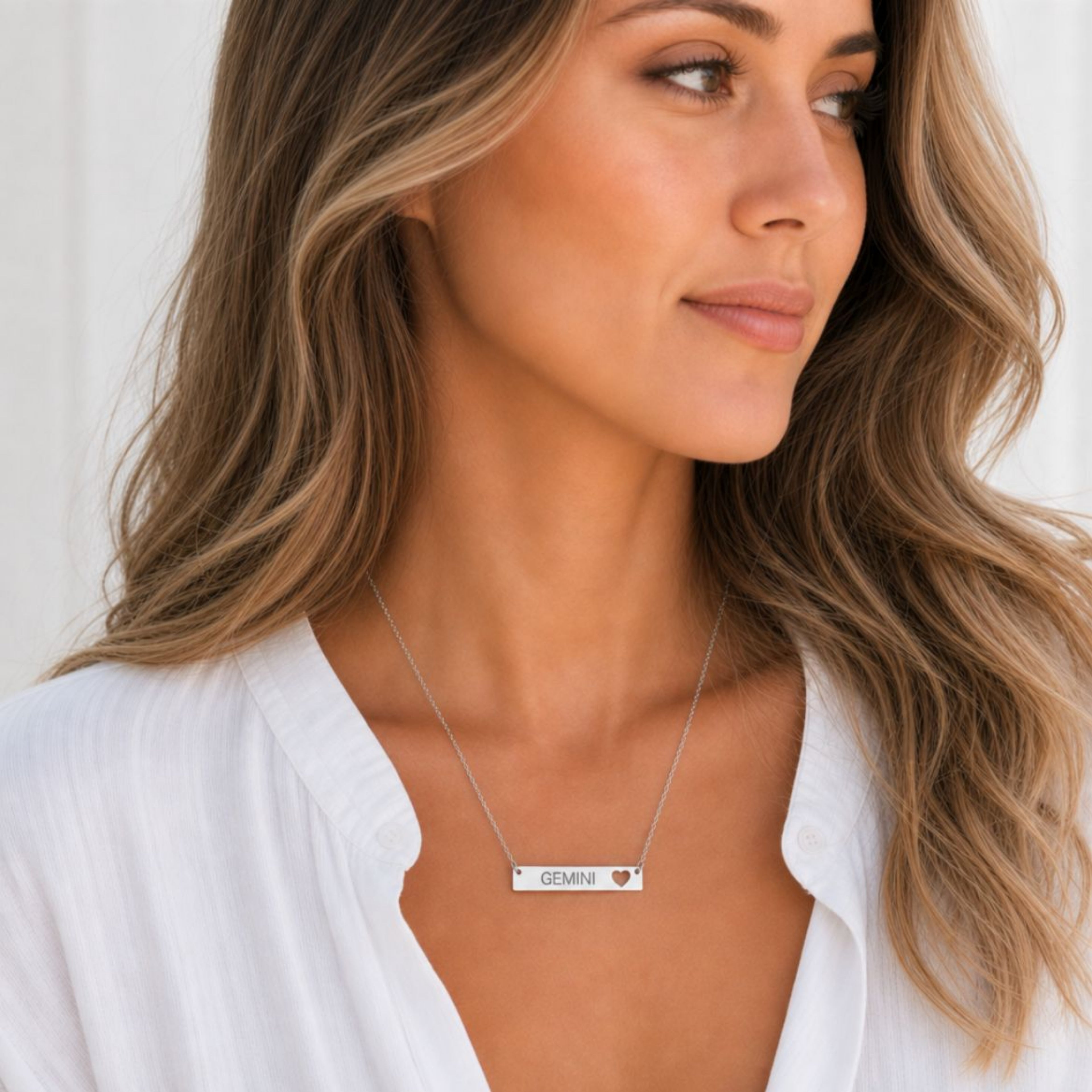 Gemini zodiac necklace — cutout heart bar pendant, 316L stainless steel polished mirror finish, model wearing pendant, on-neck lifestyle