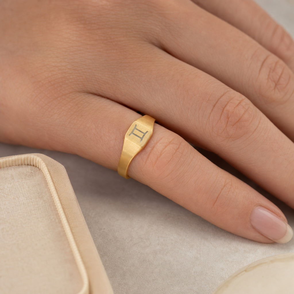 Gemini zodiac square signet ring scale-in-hand — fingers holding ring next to gift box and ruler, dainty 20mm signet sizing