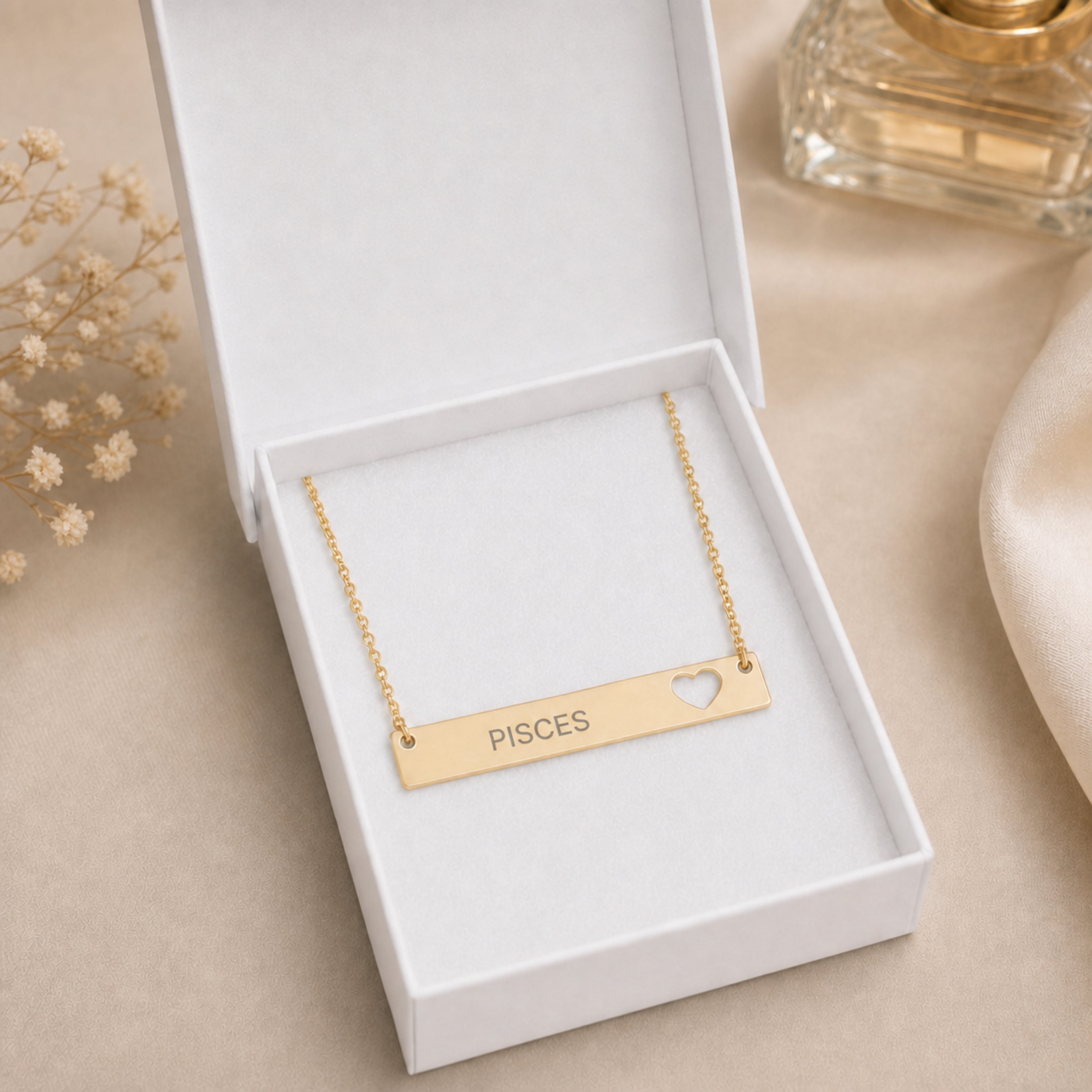 The Pisces zodiac necklace nestled in Memory That Lasts signature cream gift box — 18K Gold cutout heart bar pendant with grey laser-etched PISCES, premium unboxing moment (AI-generated image)