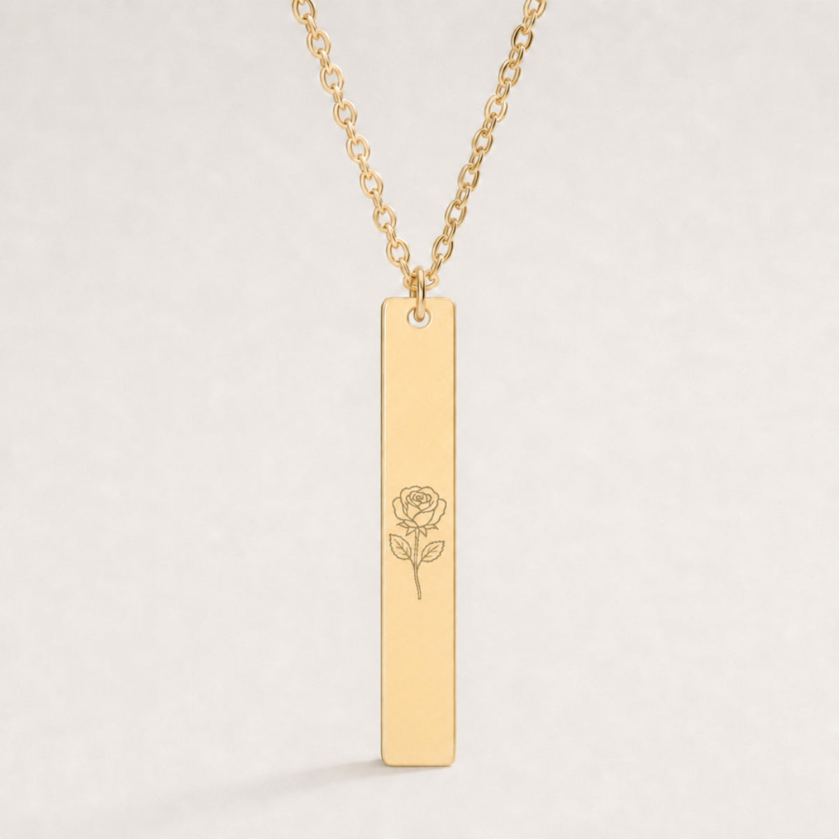 June birth flower necklace — Rose engraved on 1.26" × 0.20" vertical bar pendant, premium close-up macro hero on 18K Gold PVD
