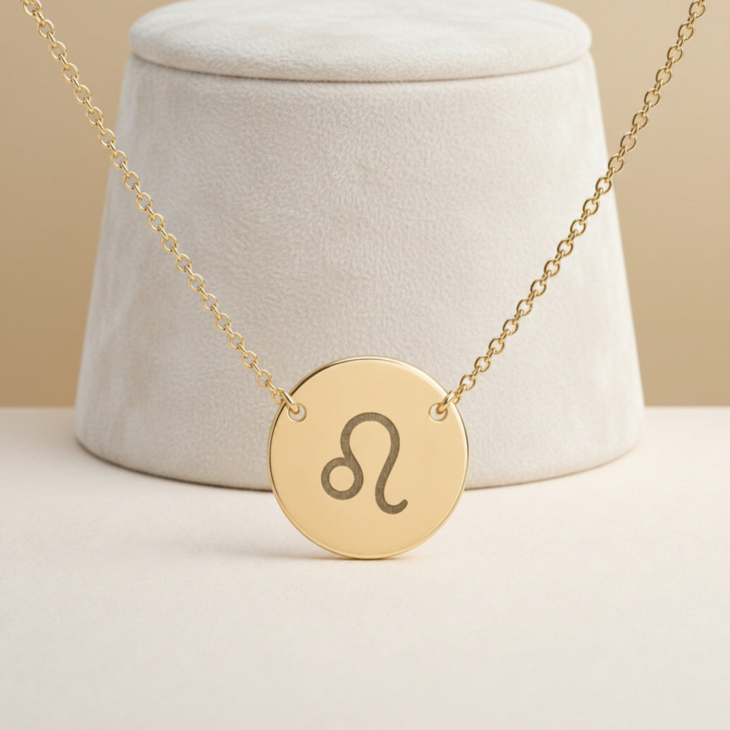 Leo Coin Gold necklace close-up detail — macro of laser-engraved Leo Lion glyph on polished 18K gold disc pendant, fine engraving detail, personalized zodiac astrology jewelry gift