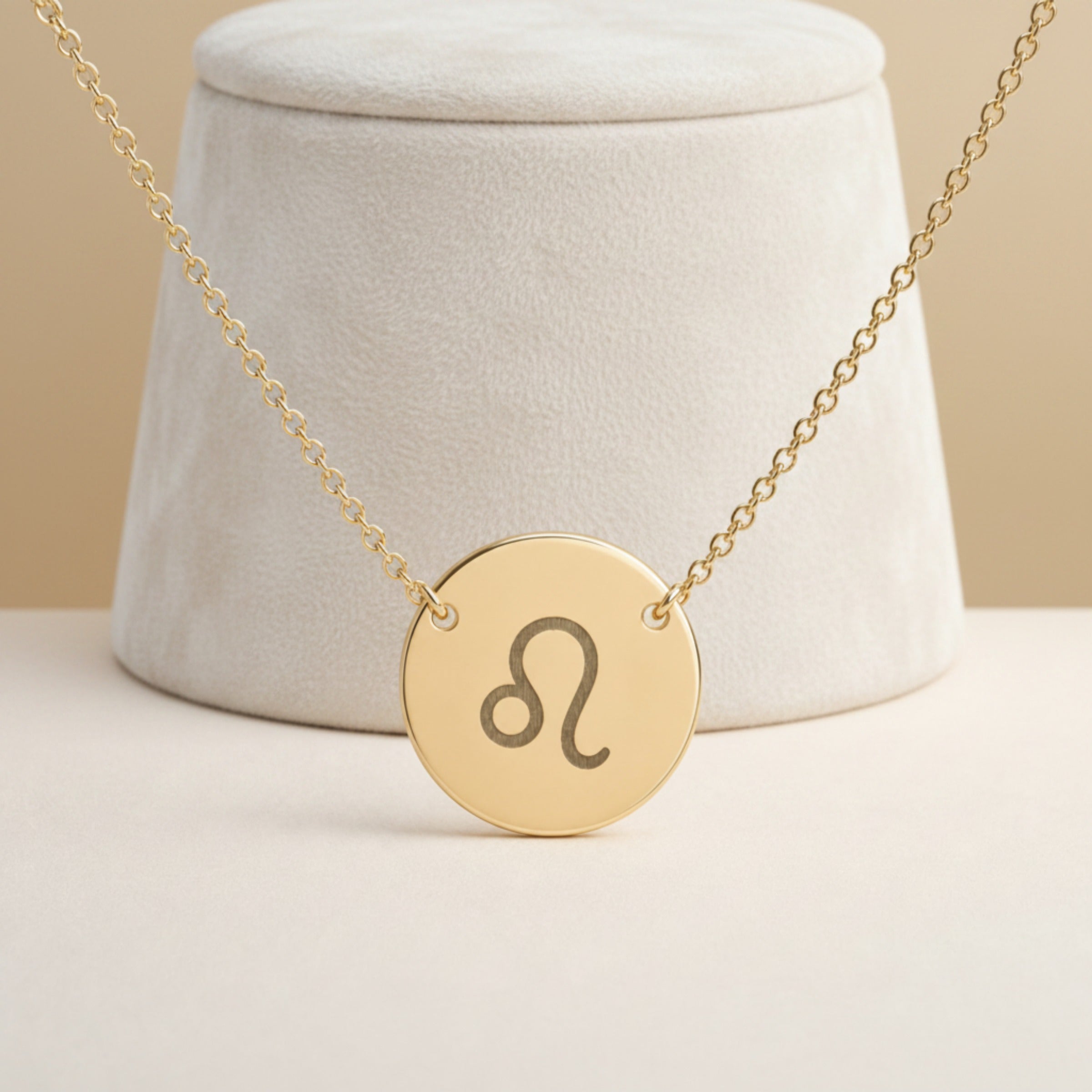 Leo Coin Gold necklace close-up detail — macro of laser-engraved Leo Lion glyph on polished 18K gold disc pendant, fine engraving detail, personalized zodiac astrology jewelry gift