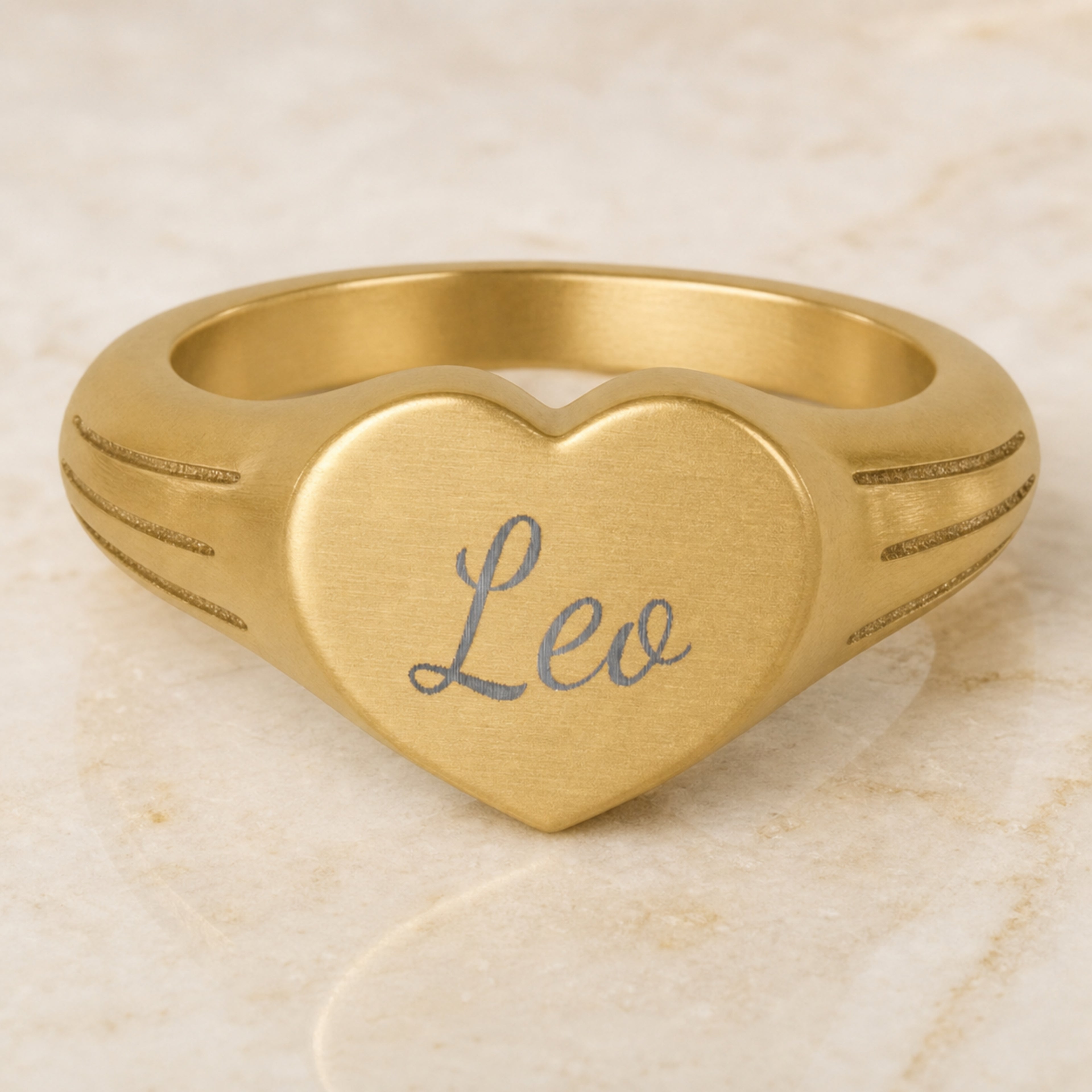 Leo heart signet ring — engraved Leo star sign on 18K gold heart signet ring, studio macro hero