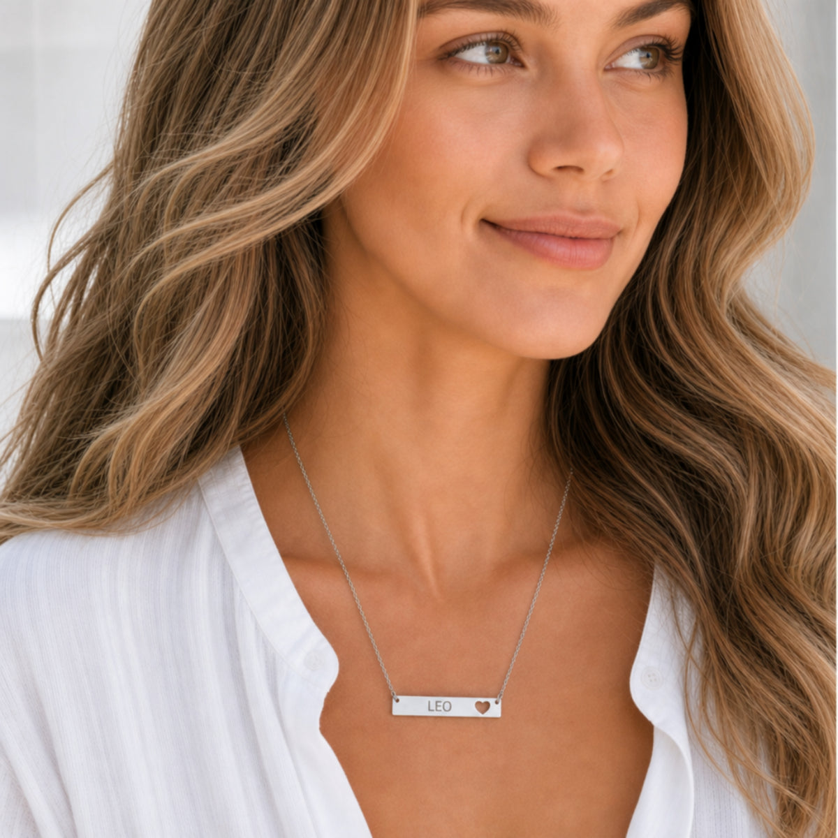 Leo zodiac necklace — cutout heart bar pendant, 316L stainless steel polished mirror finish, model wearing pendant, on-neck lifestyle