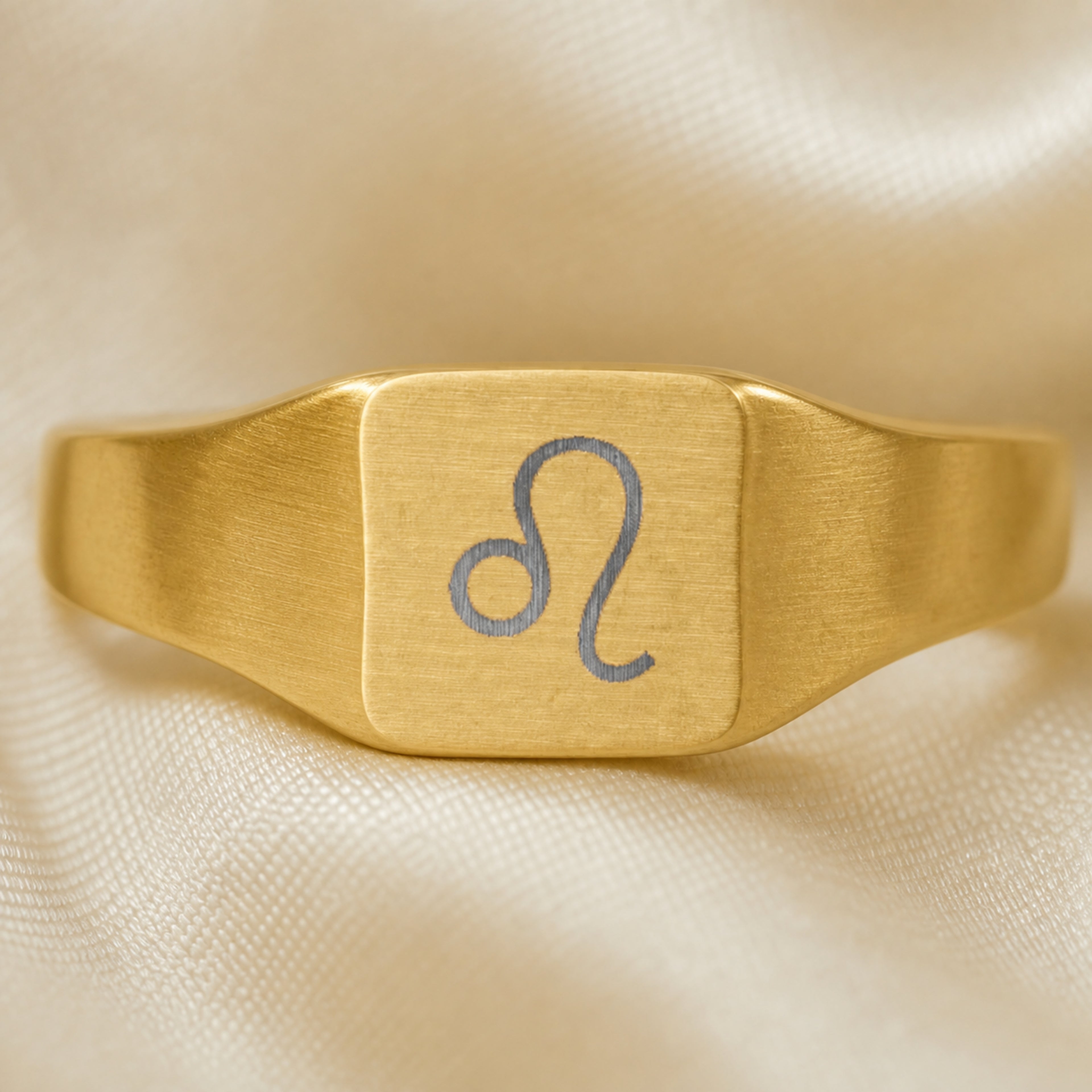 Leo zodiac square signet ring engraving close-up — laser-etched Lion detail, brushed grey on matte gold