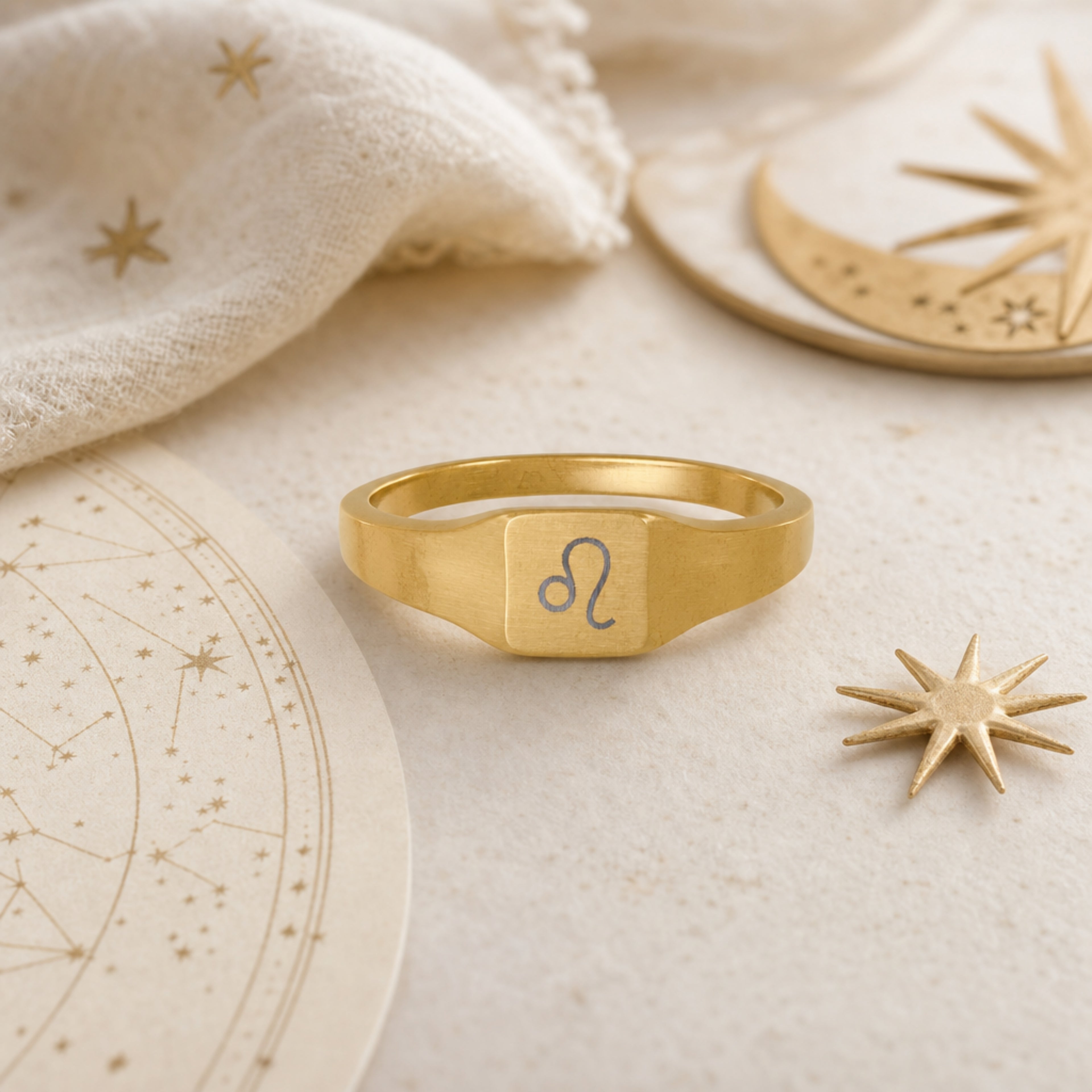 Leo zodiac square signet ring celestial flatlay — zodiac chart and brass star with engraved Leo signet, astrology gift styling