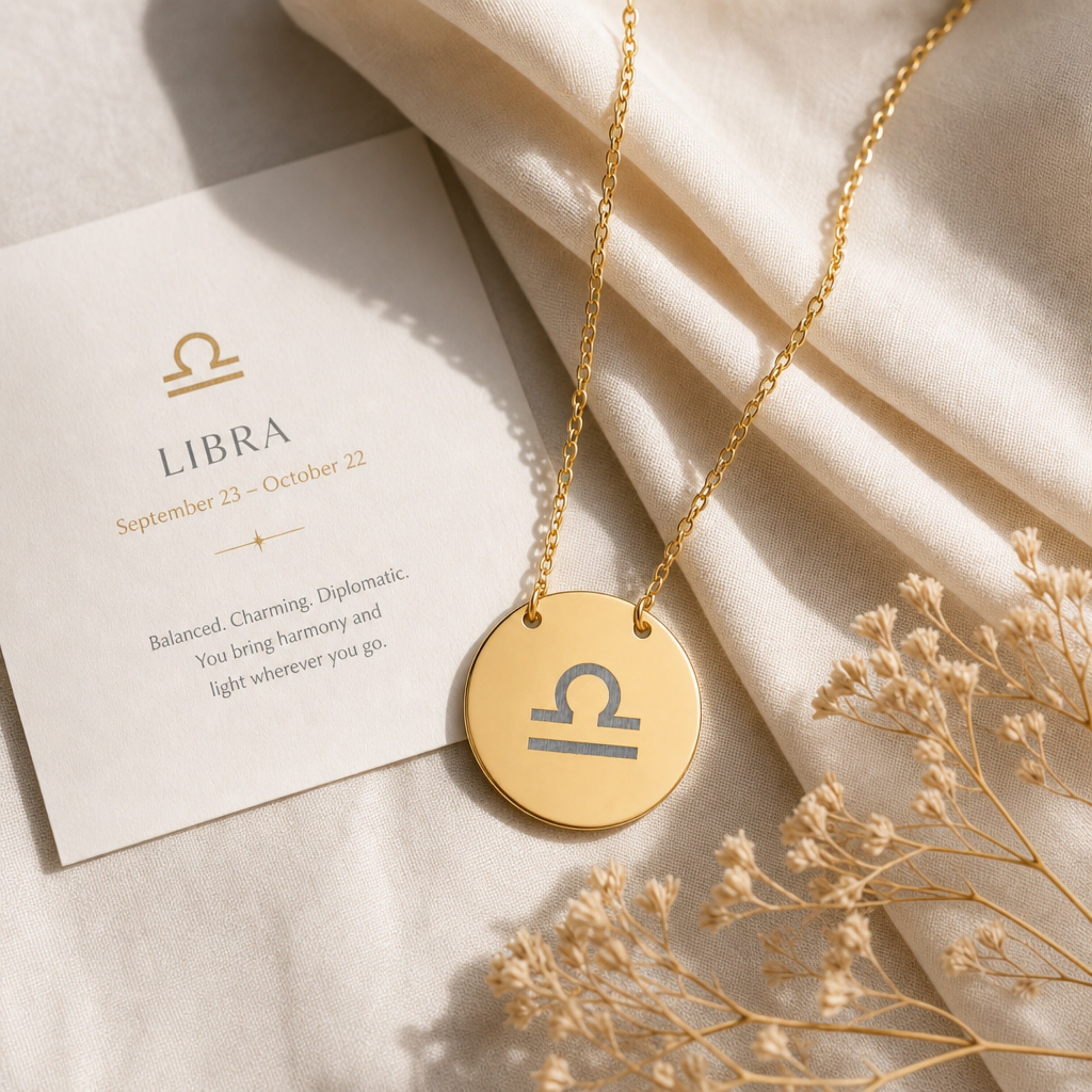Libra Coin Gold zodiac necklace flatlay — 18K gold pendant engraved with Libra Scales star sign on cream silk, premium personalized astrology necklace gift for October birthday, Libra woman, mother, daughter