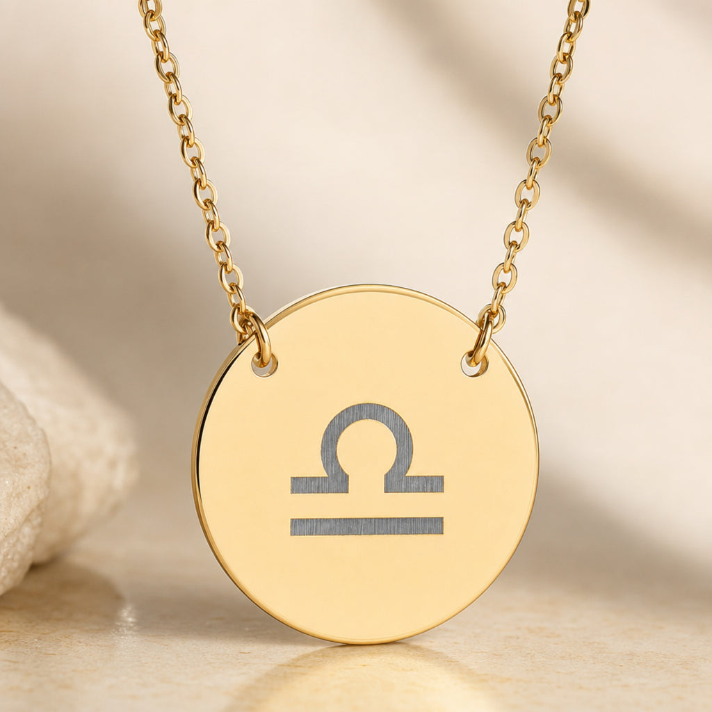 Libra Coin Gold necklace close-up detail — macro of laser-engraved Libra Scales glyph on polished 18K gold disc pendant, fine engraving detail, personalized zodiac astrology jewelry gift