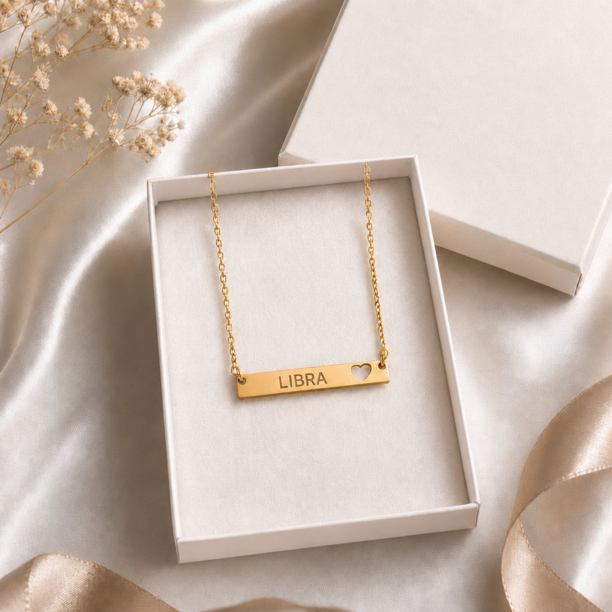 Libra zodiac necklace — cutout heart bar pendant in cream gift-ready box, premium editorial unboxing