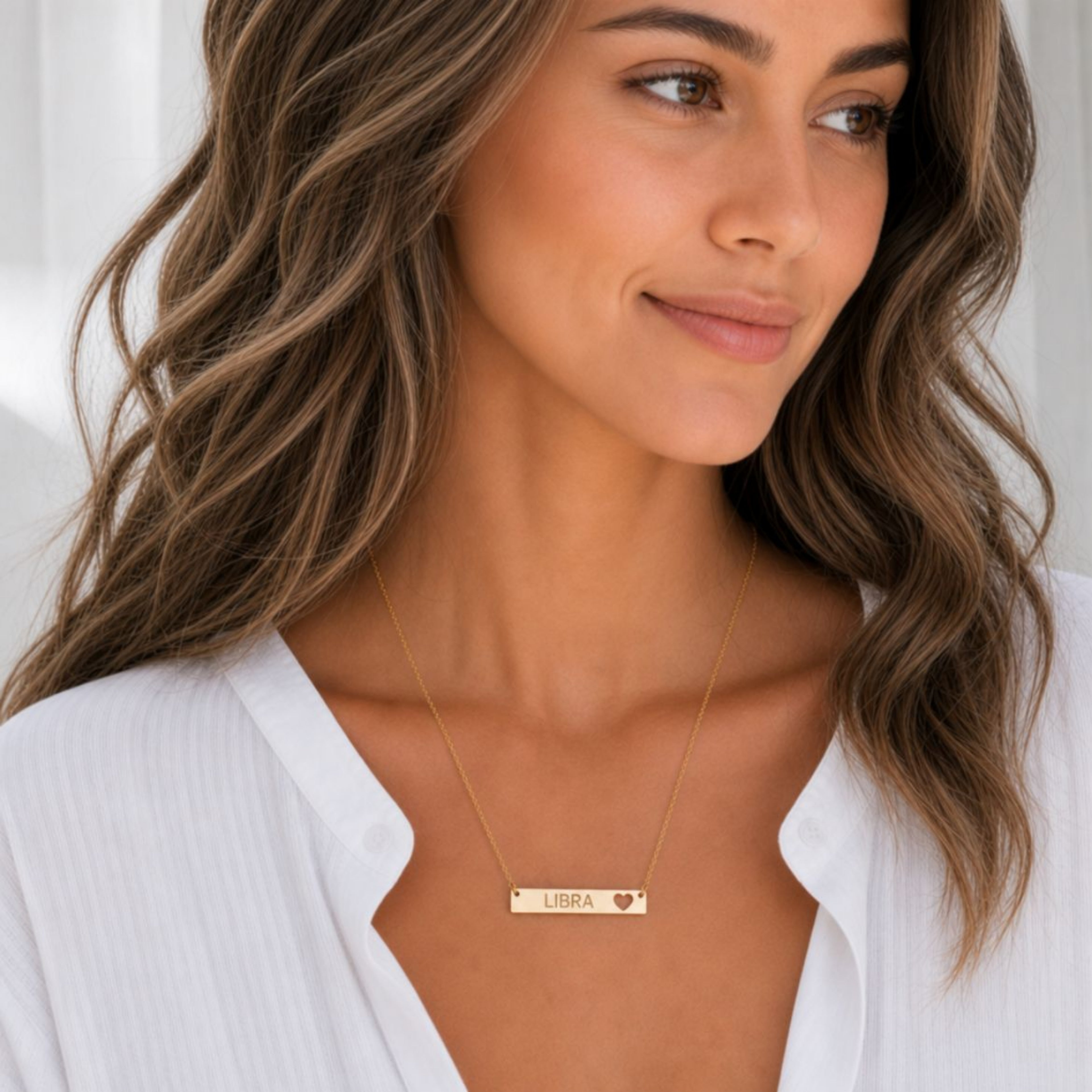 Libra zodiac necklace — cutout heart bar pendant, 18K Gold PVD finish, model wearing pendant, on-neck lifestyle