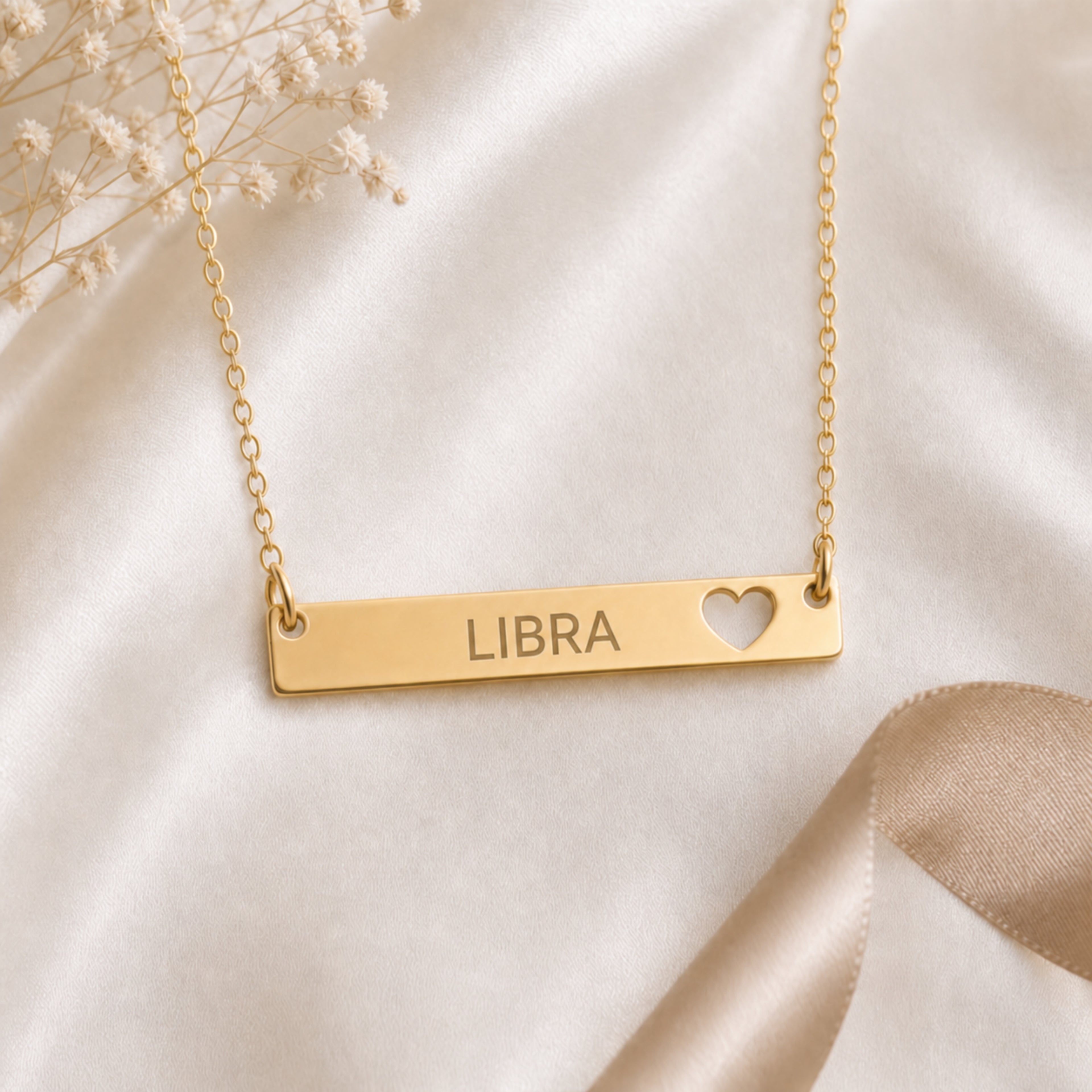 Libra zodiac necklace — cutout heart bar pendant flatlay with dried botanicals on cream linen