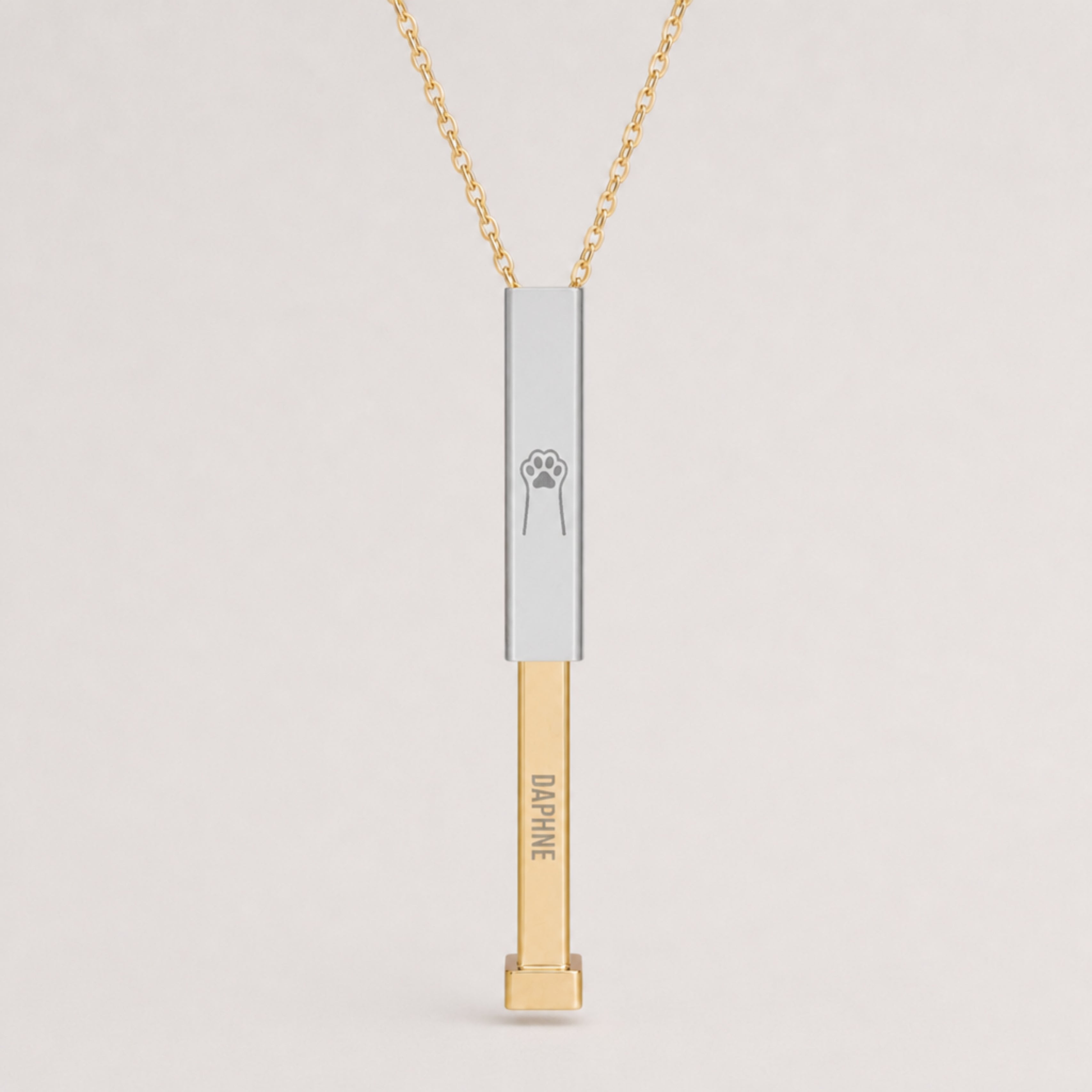 Close-up of the engraved cat paw hidden-message sliding bar pendant