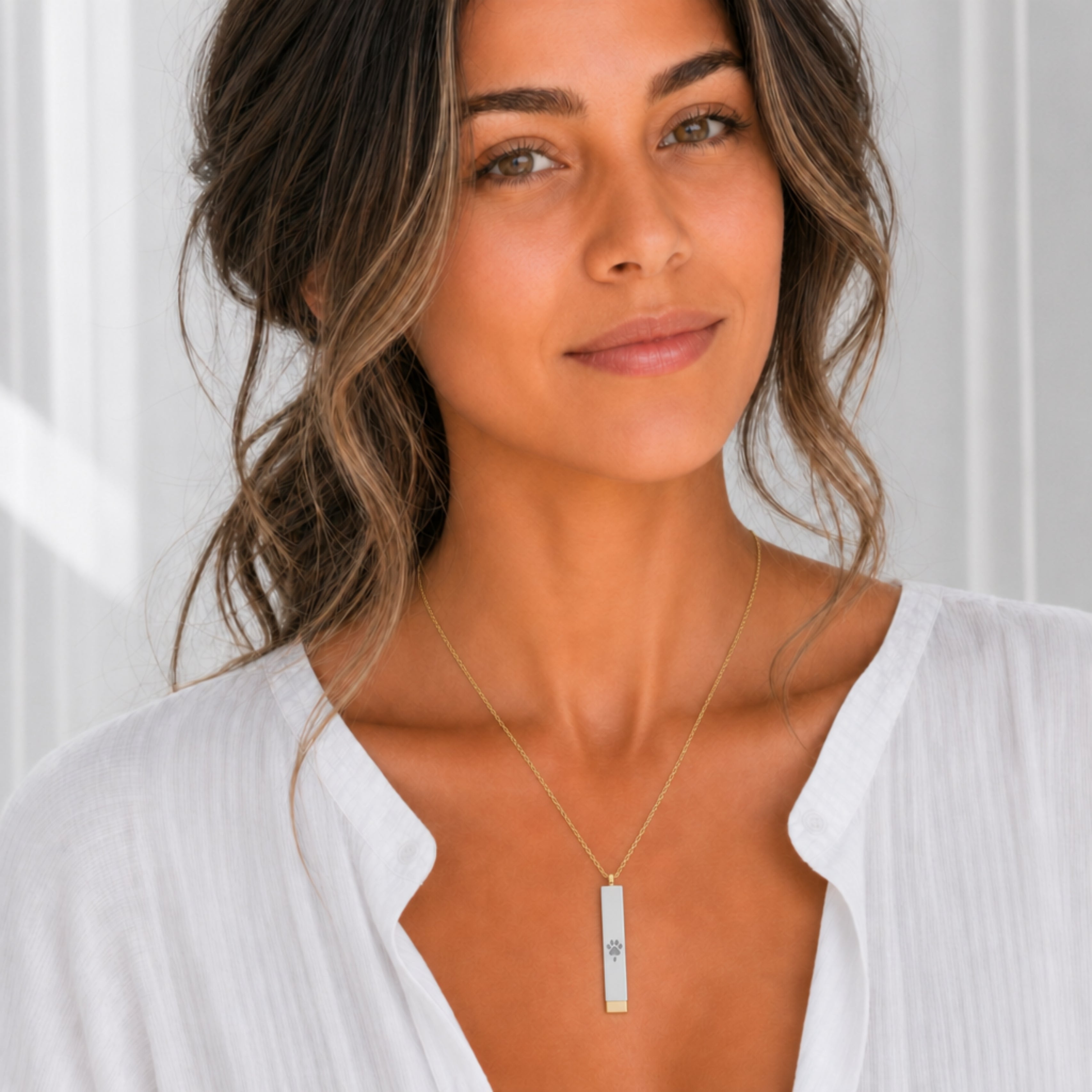 Hidden message sliding bar necklace with engraved dog paw, worn closed — personalized gold and stainless steel keepsake