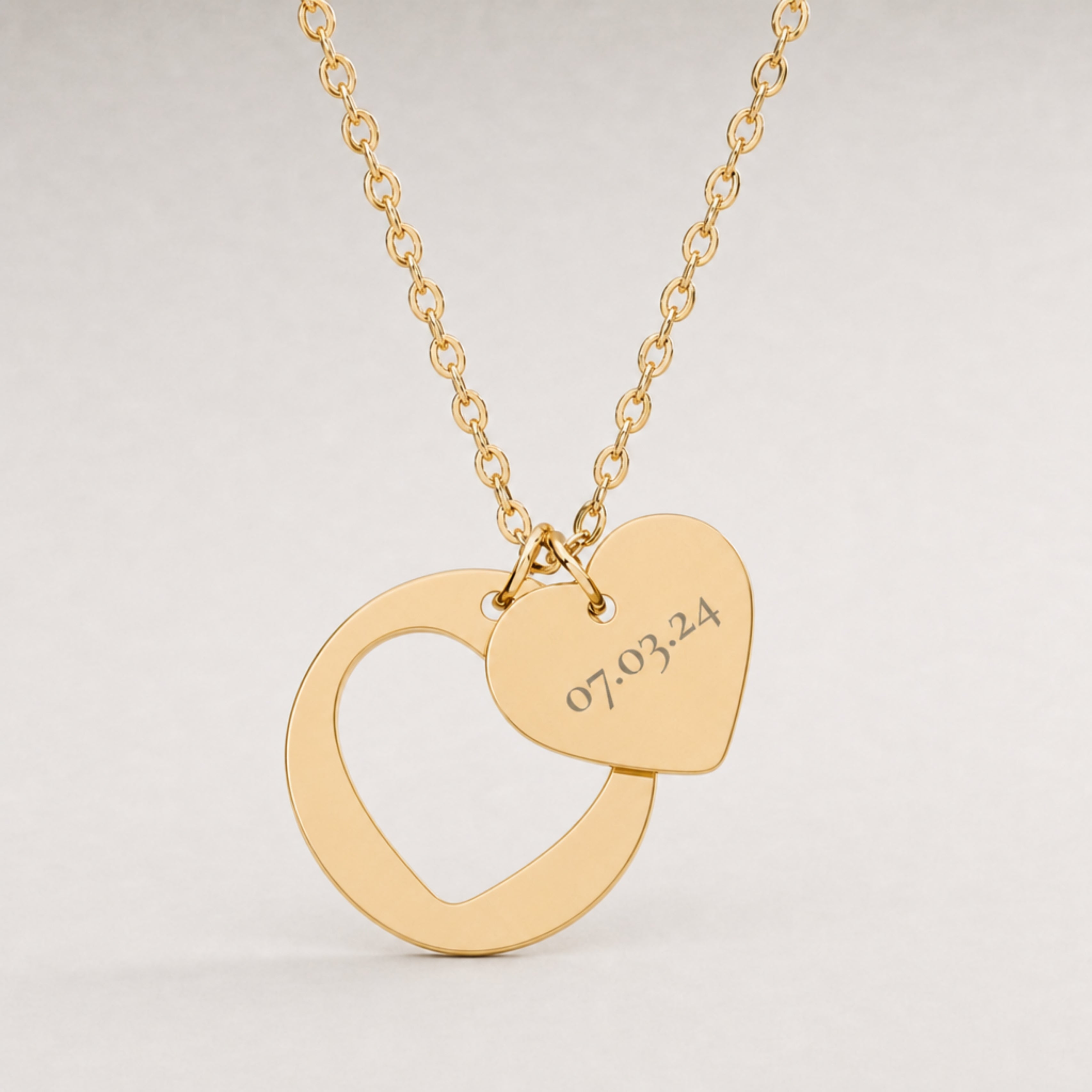 Close-up of the engraved initial on the heart cutout pendant