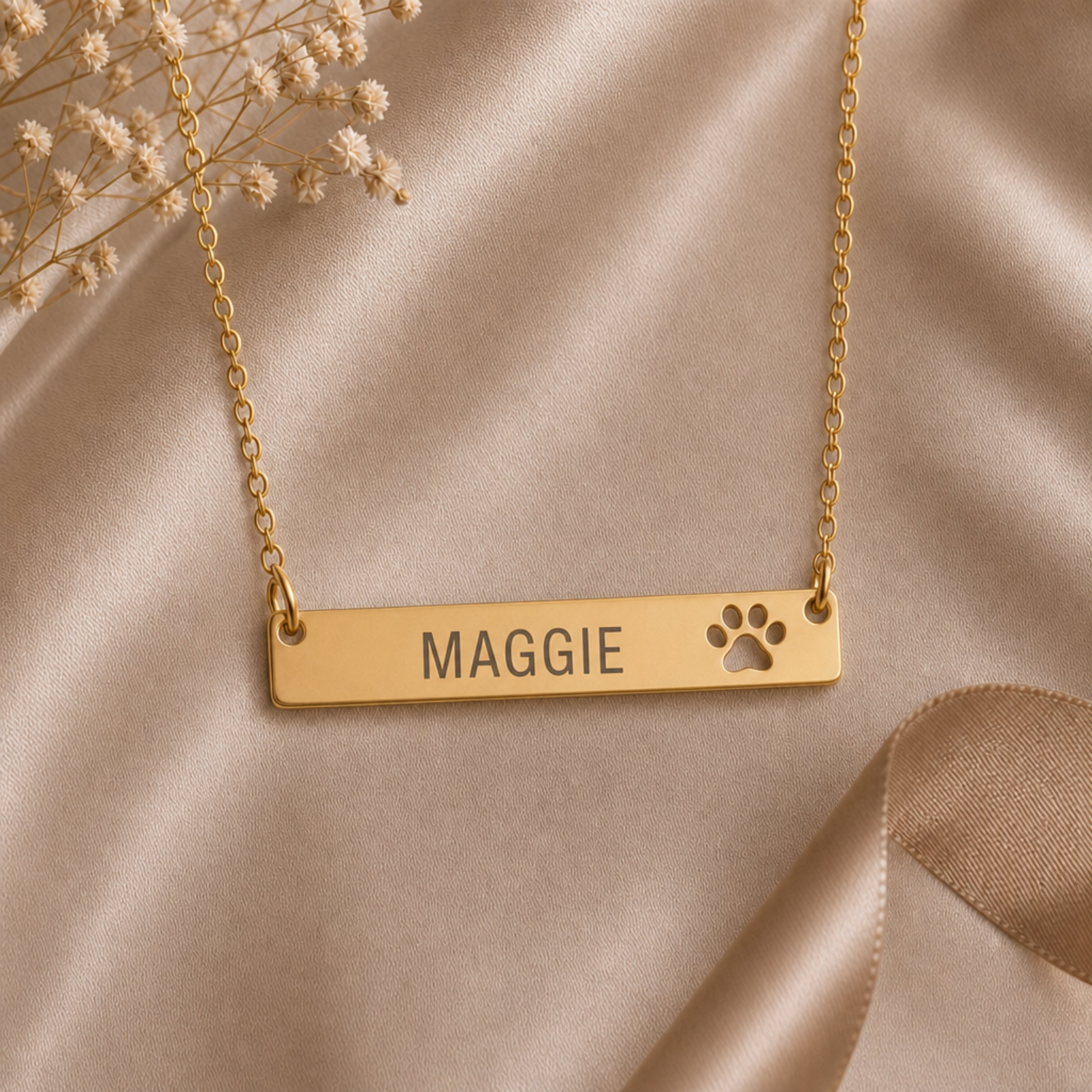 Flatlay of the personalized paw cutout name bar necklace, minimal engraved pet pendant